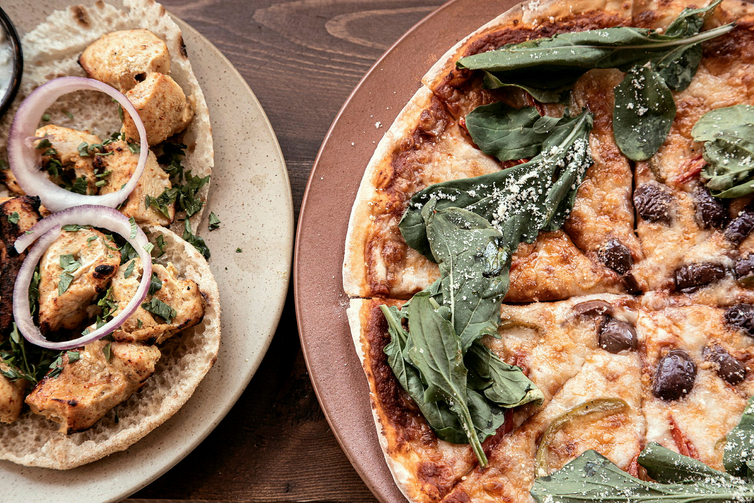 Matbild som visar kycklingwraps och pizza. (AI-genererad text)