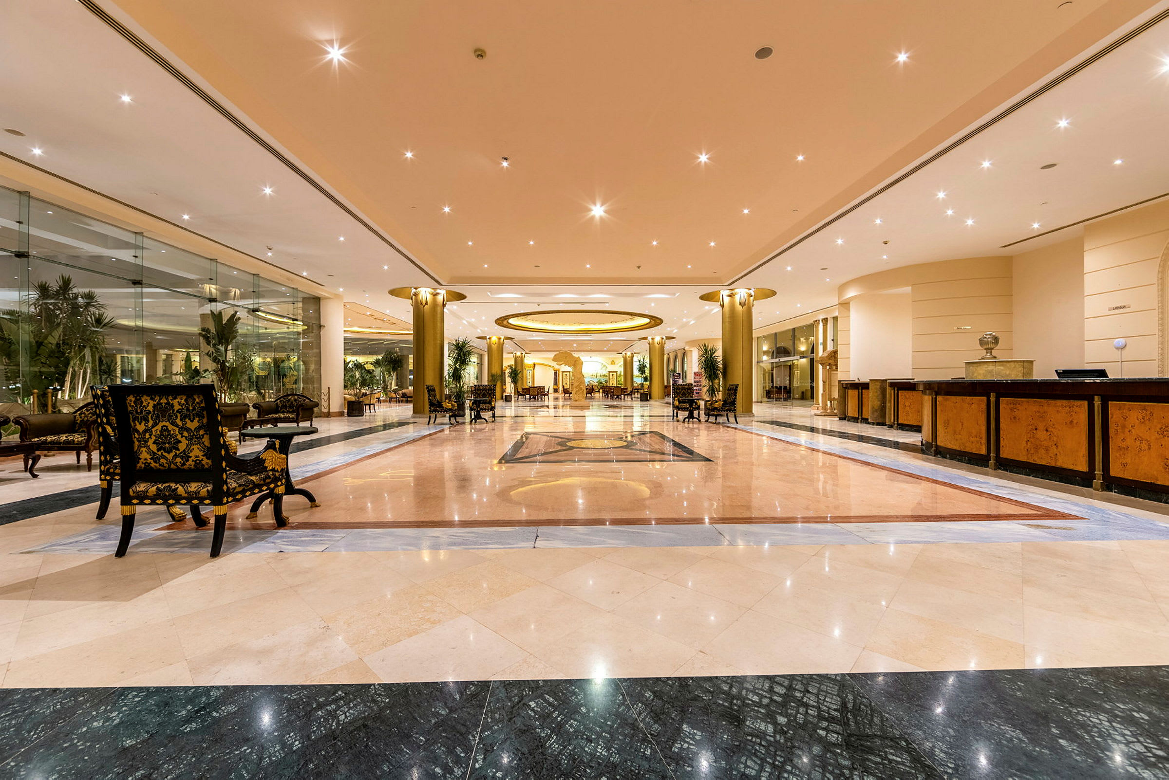Interiör av en hotellobby med marmorgolv och takbelysning. (AI-genererad text)
