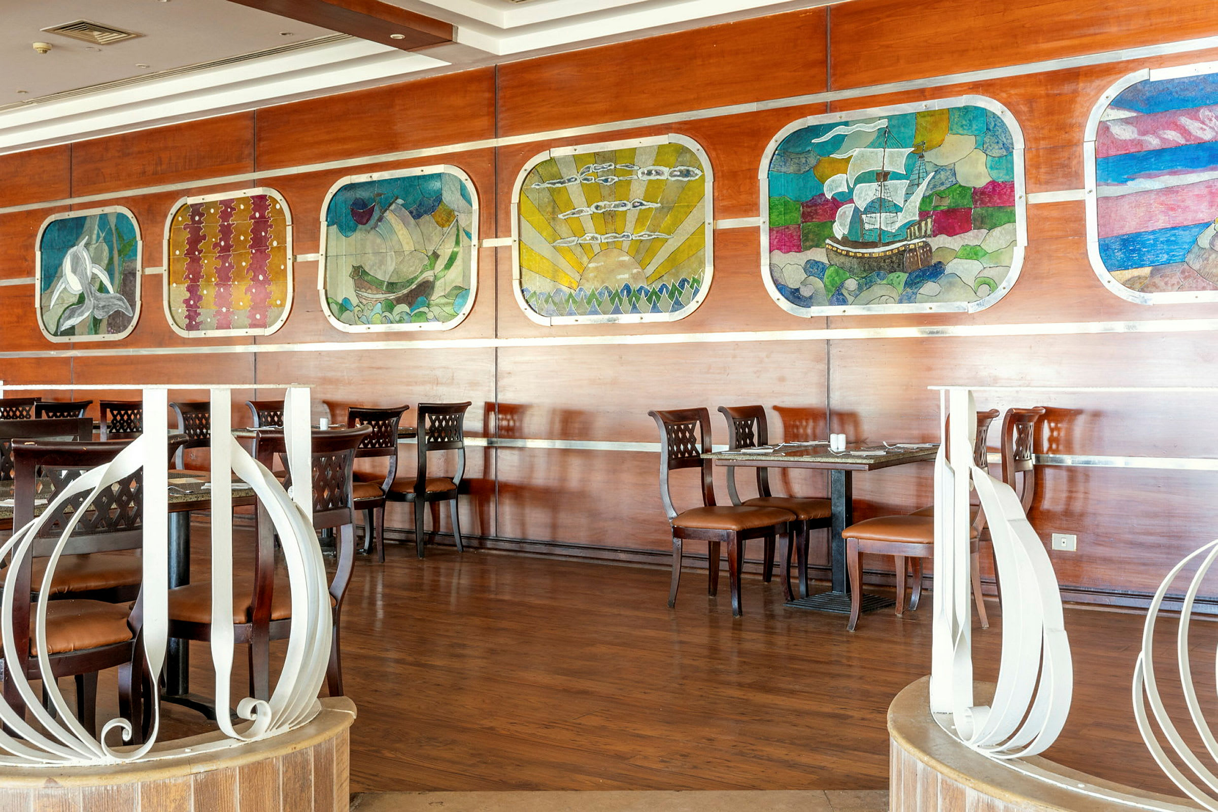 En restaurang med träinredning och konstverk på väggen. (AI-genererad text)