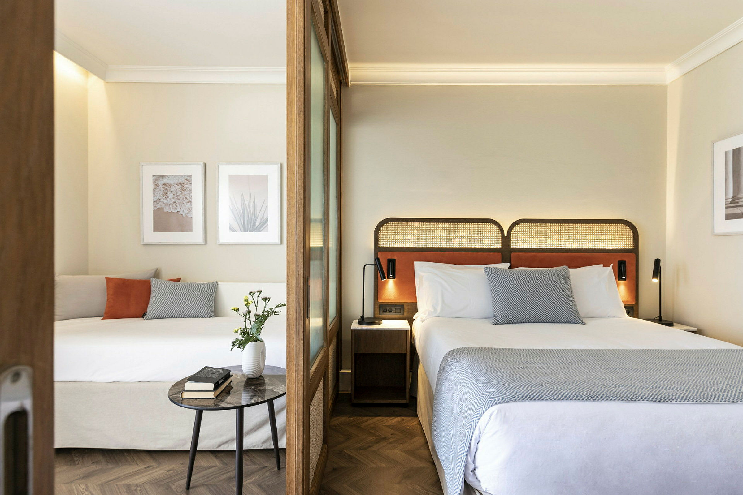 Modernt hotellrum med två sängar, dekorativa tavlor och inredning. (AI-genererad text)