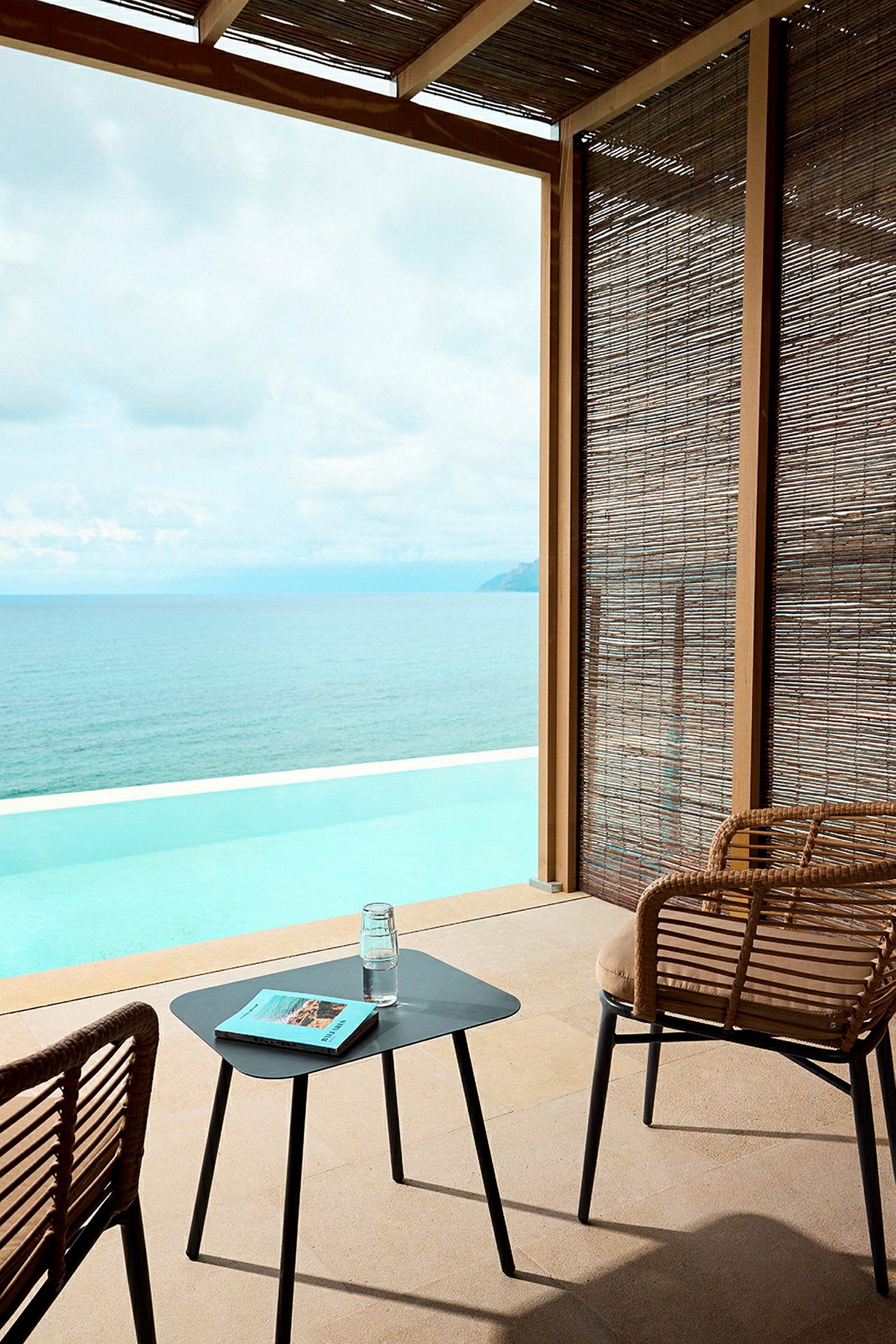 En sittgrupp med utsikt över en infinitypool och hav. (AI-genererad text)