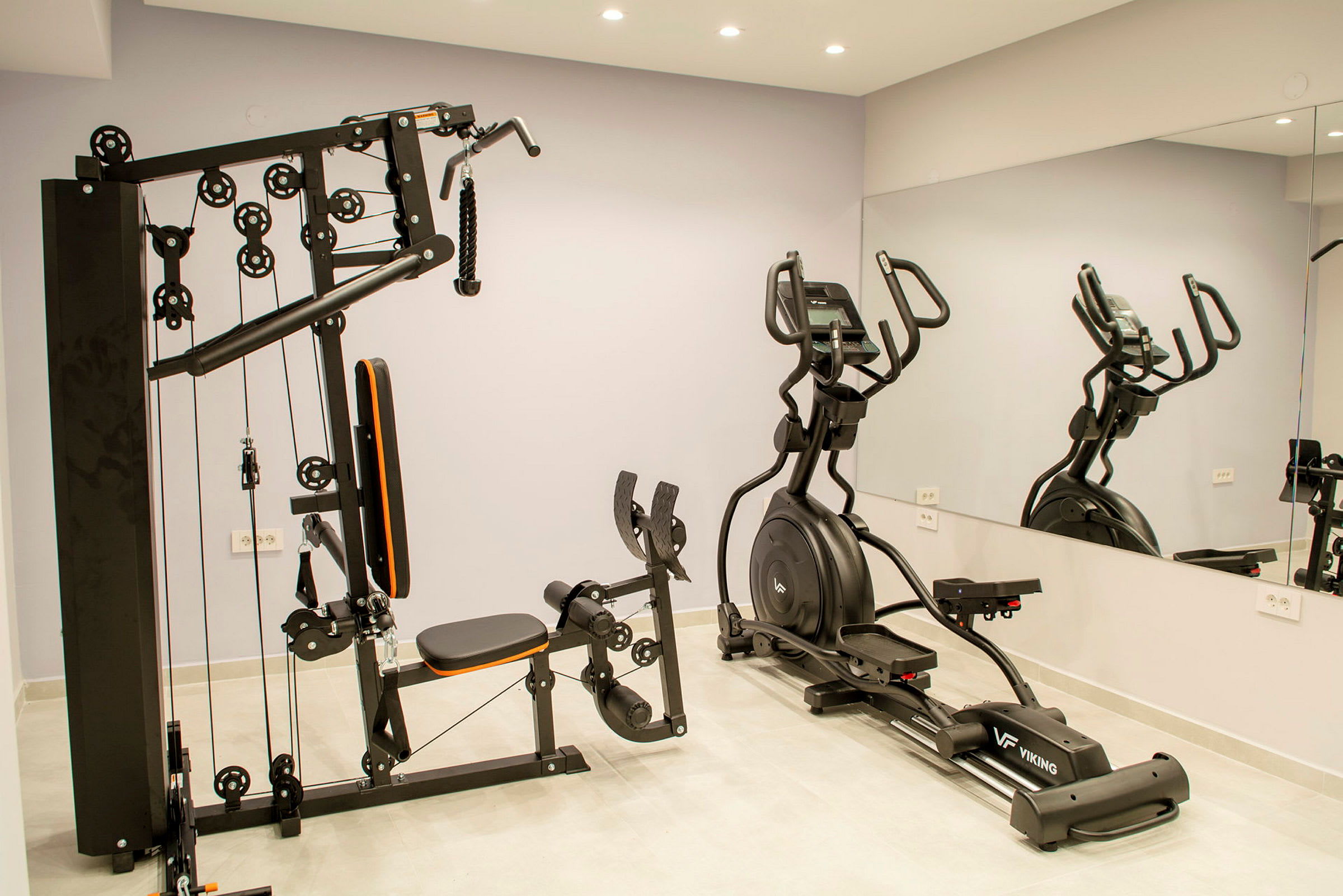 En träningsmaskin och en elliptisk träningsmaskin i ett gym. (AI-genererad text)