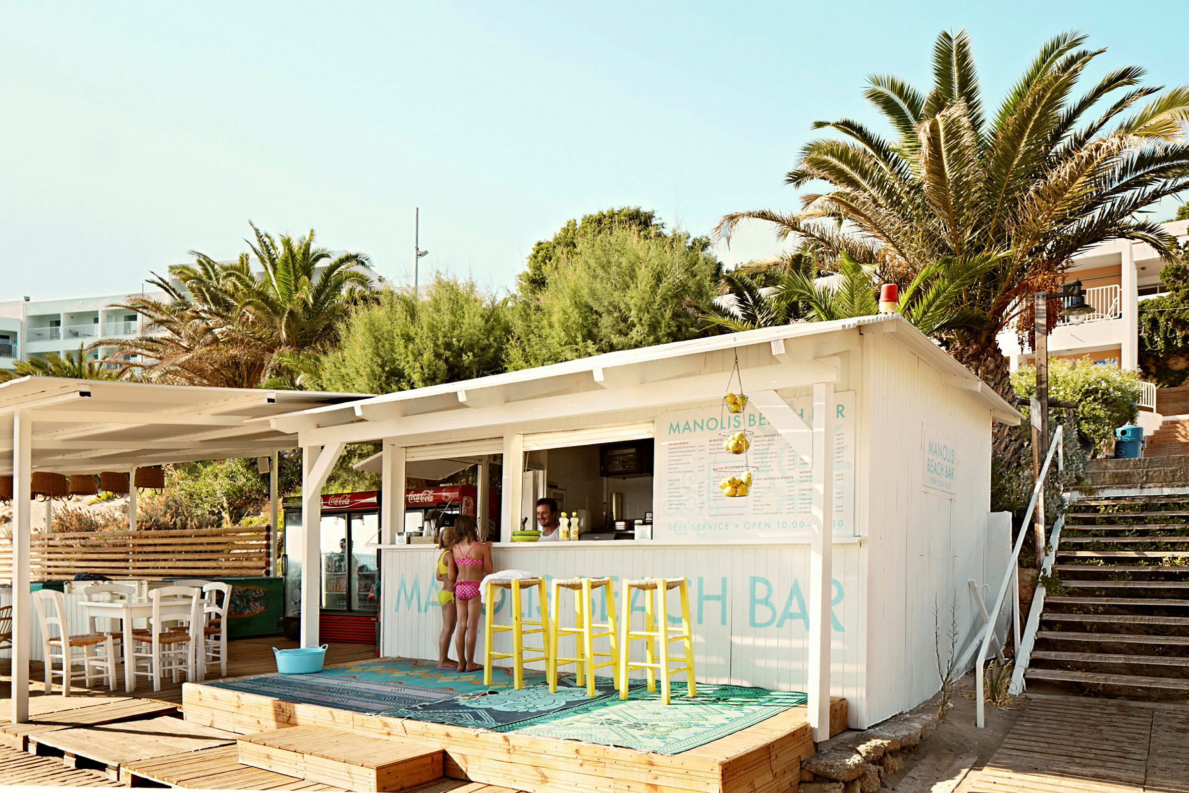 En liten strandbar med palmträd i bakgrunden. (AI-genererad text)