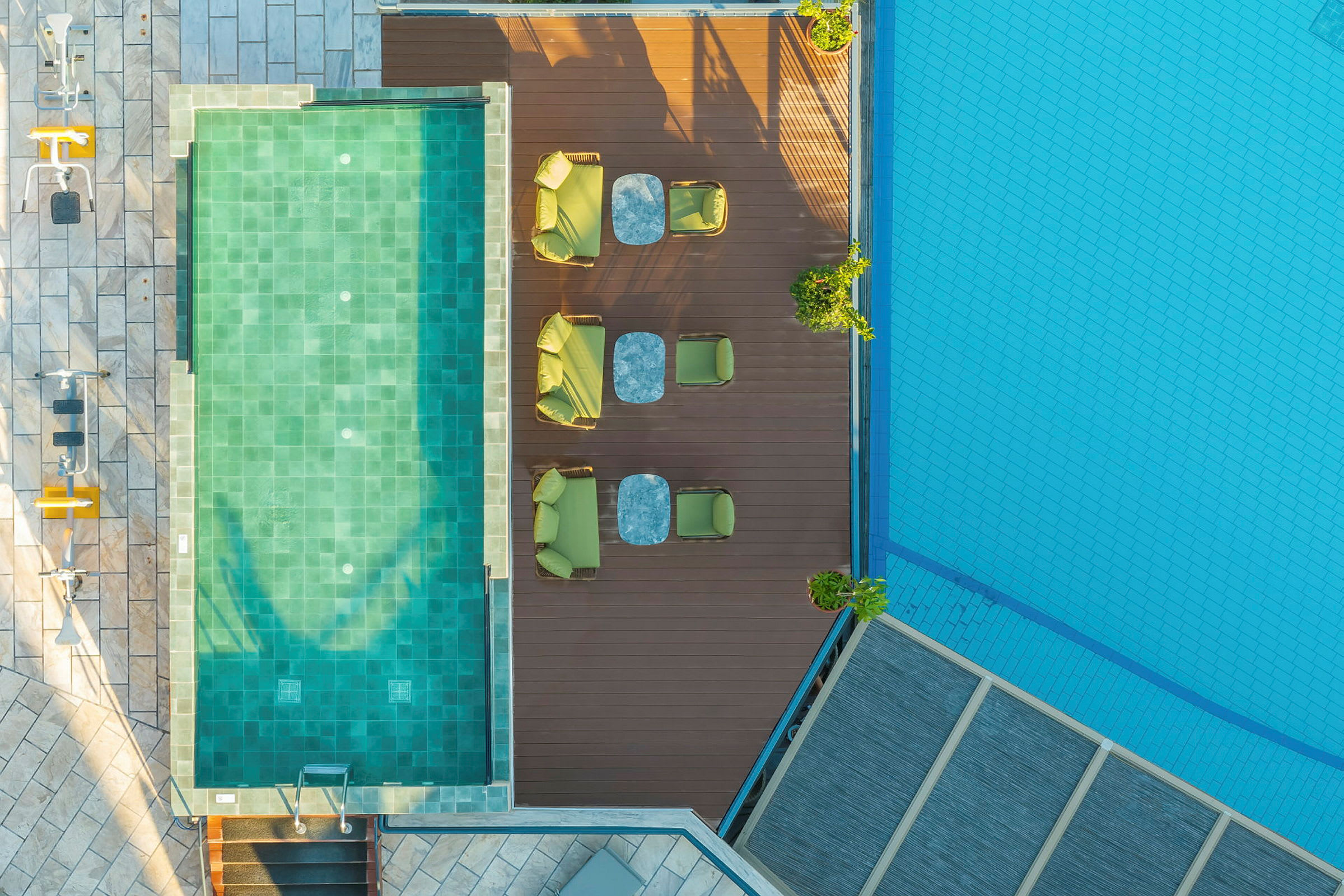 Flygbild av en pool och en träveranda med sittplatser. (AI-genererad text)