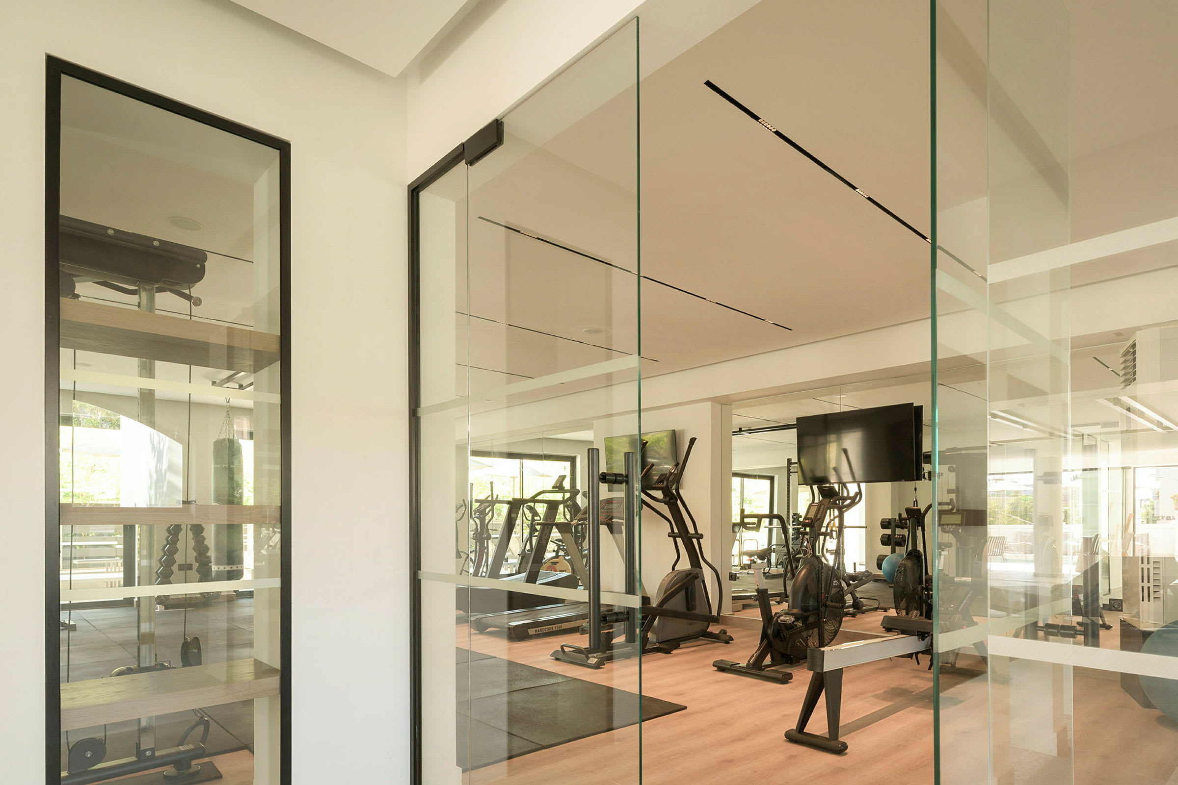Fitnessrum med träningsutrustning och spegelväggar. (AI-genererad text)