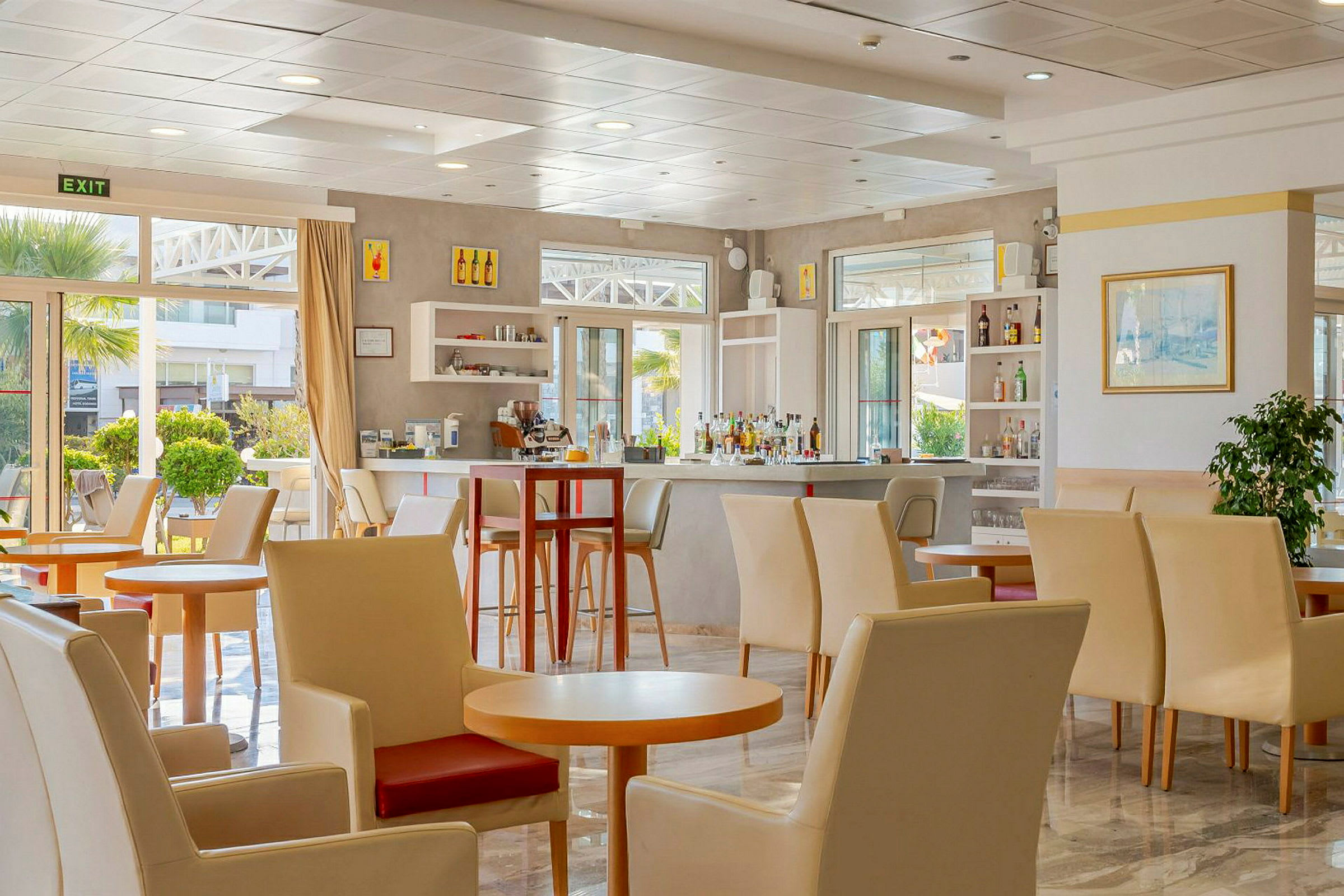 Ett ljust och modernt café med sittplatser och en bar. (AI-genererad text)