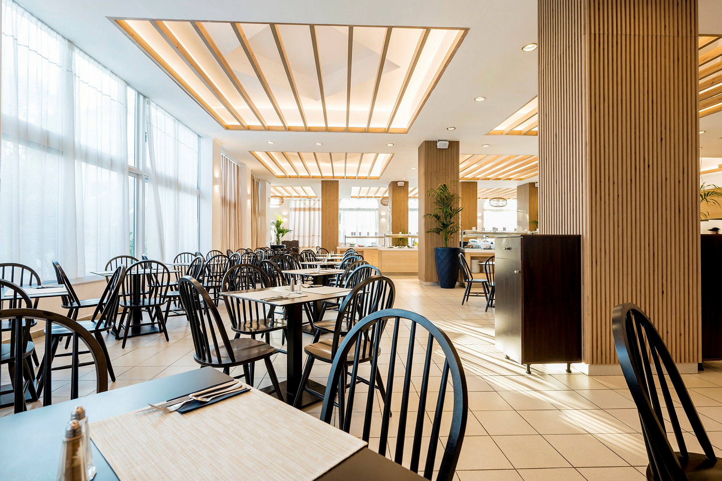 Restaurang med bord, stolar och modern dekor. (AI-genererad text)
