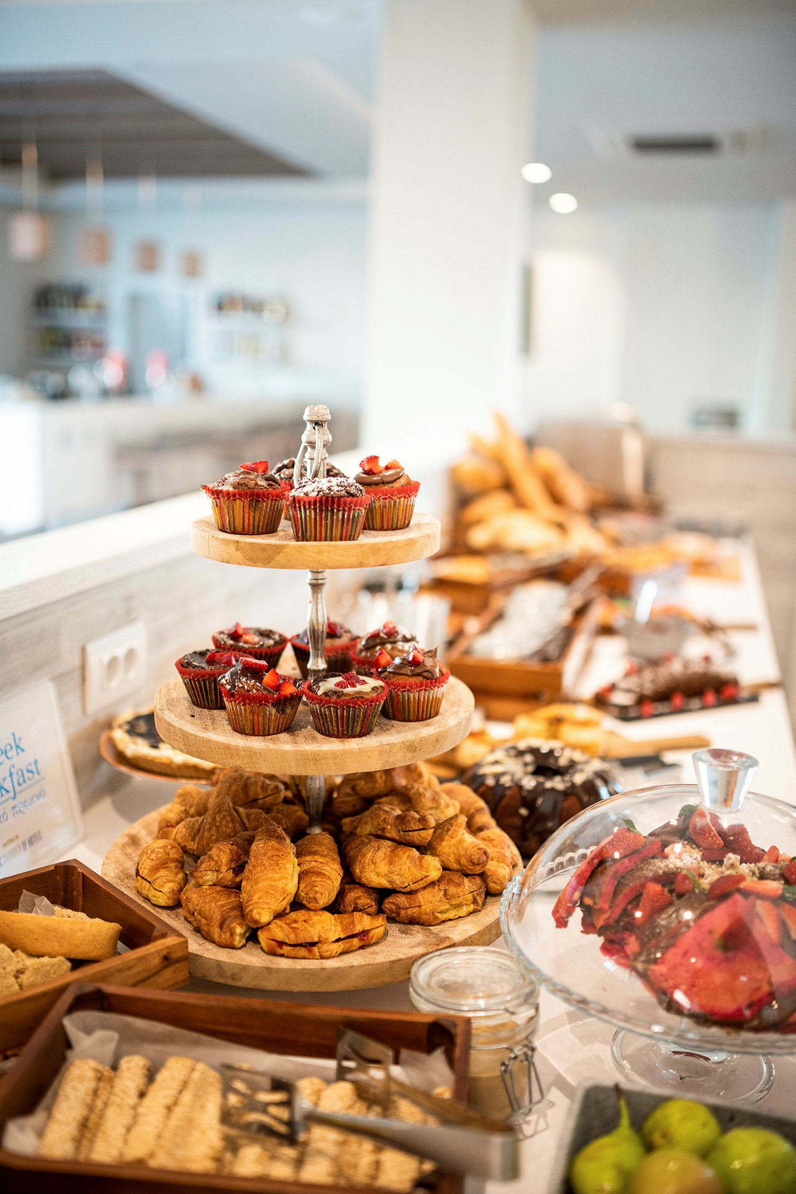 En frukostbuffé med bakverk och frukt. (AI-genererad text)