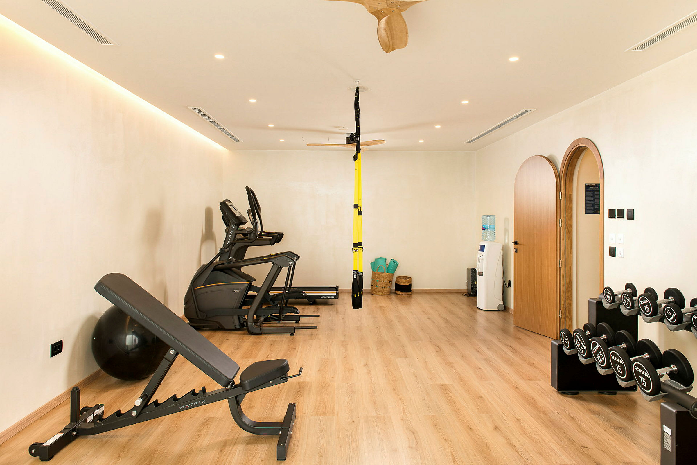 Ett gym med träningsmaskiner, hantlar, och yogamattor. (AI-genererad text)