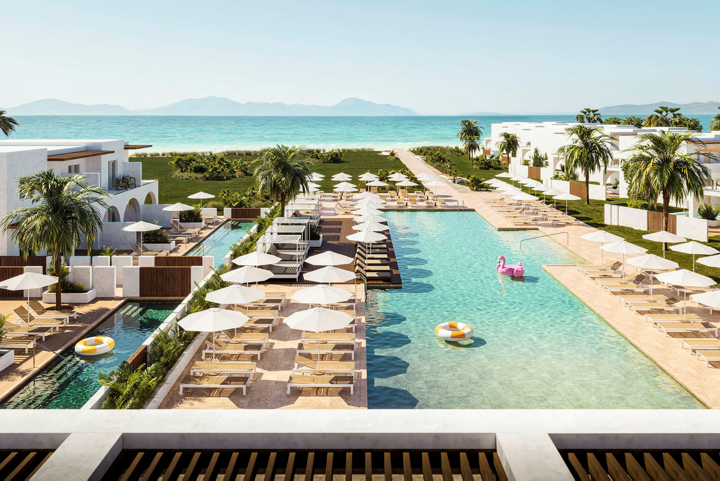 Bild av en semesterresort med pooler, solstolar och parasoller nära havet. (AI-genererad text)
