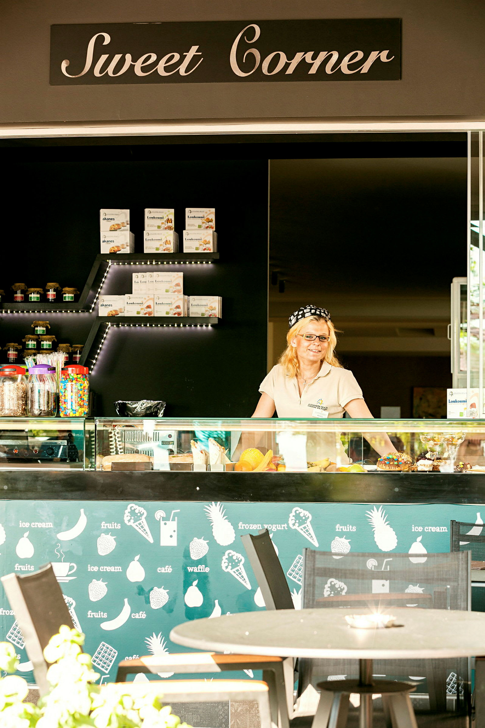 En cafédisk kallad Sweet Corner med olika bakverk och färgglada tillbehör. (AI-genererad text)