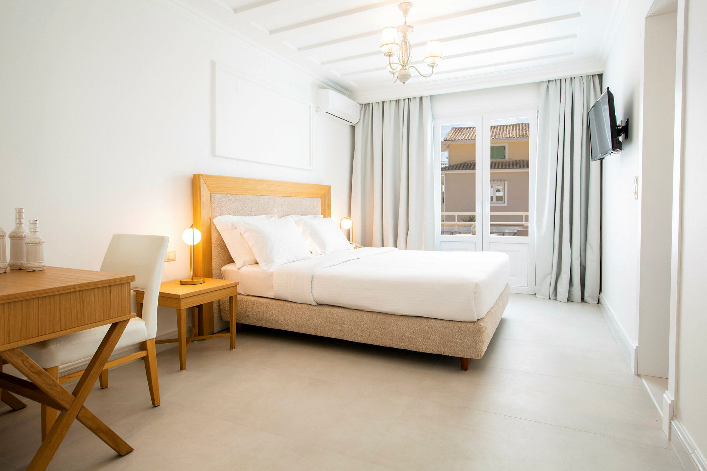 Ett ljust hotellrum med en bekväm dubbelsäng, ett skrivbord och en stol. (AI-genererad text)