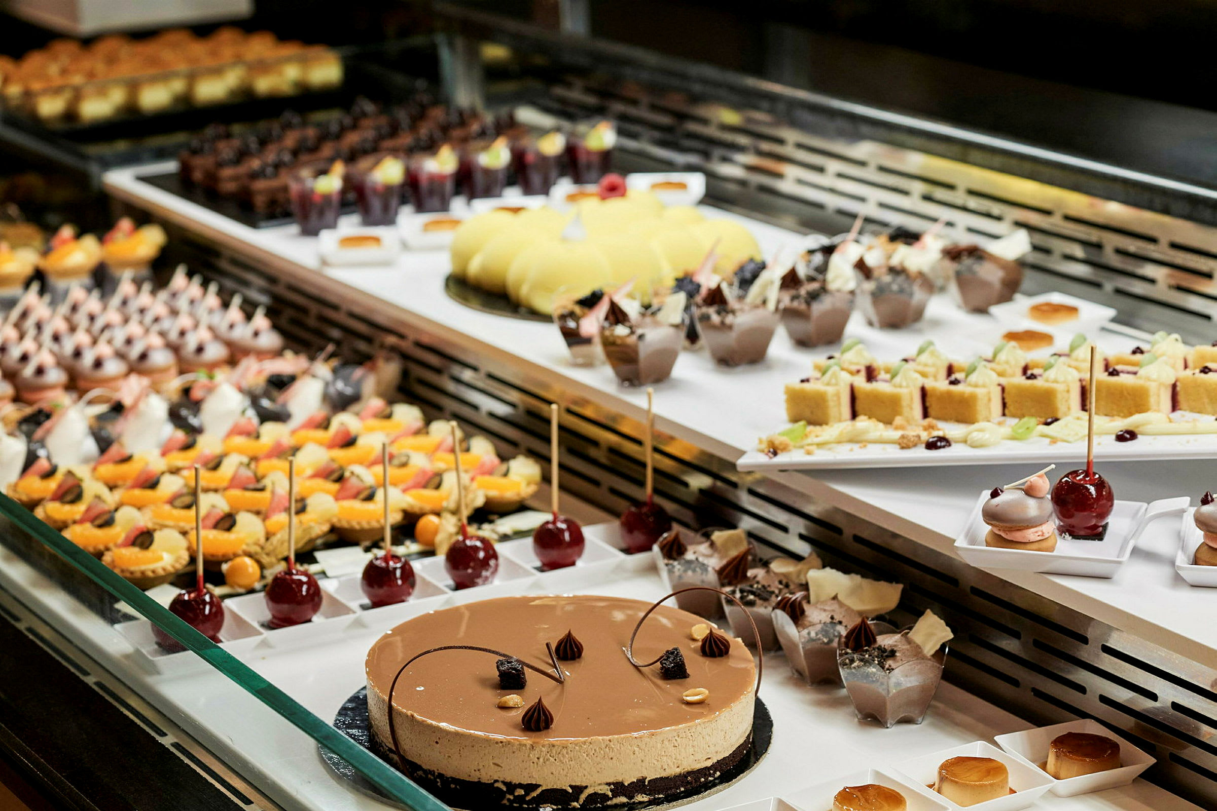 En glassmonter med olika dessertalternativ, inklusive kakor och pajer. (AI-genererad text)