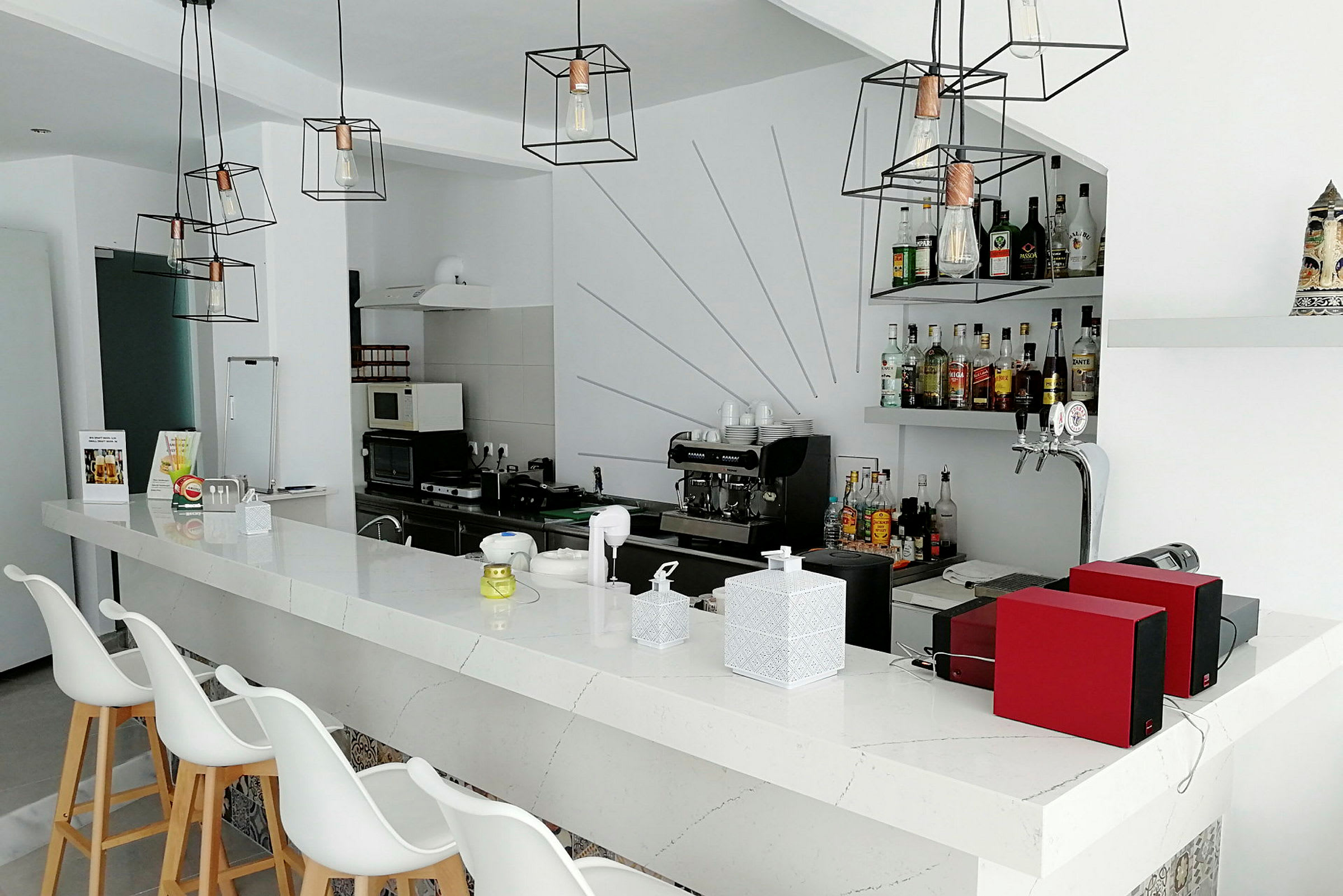 En modern bar med minimalistisk design och flera flaskor alkohol på hyllan. (AI-genererad text)