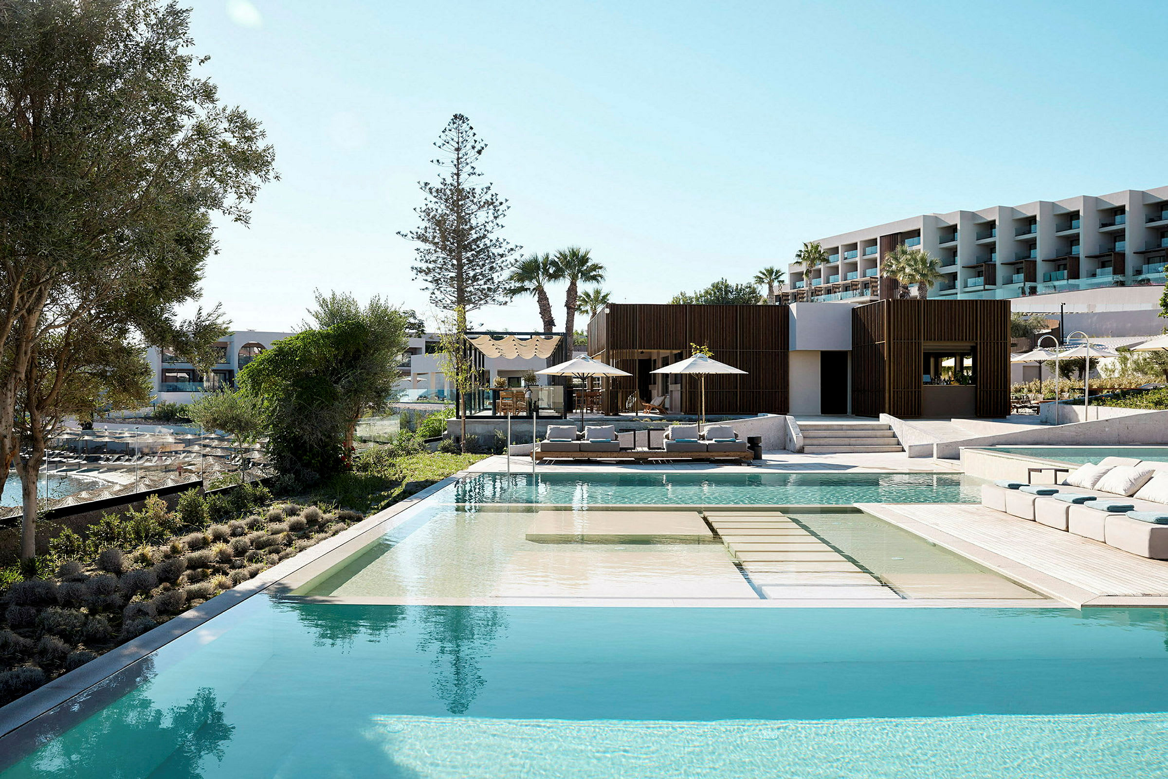Utomhusområde med pool, solstolar och moderna byggnader. (AI-genererad text)