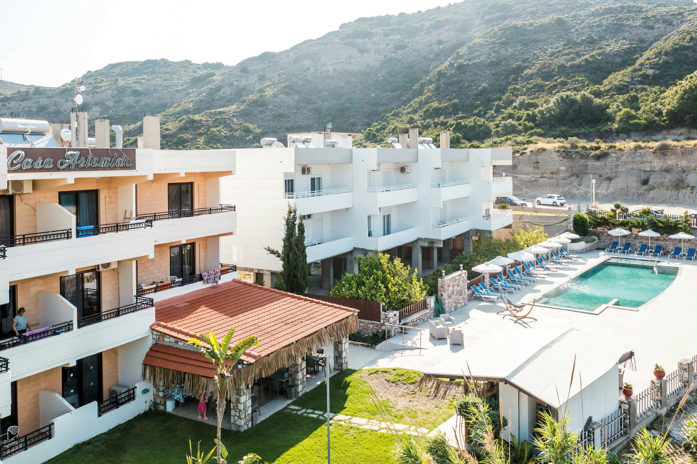 Ett hotell med pool och grönskande omgivning vid berg. (AI-genererad text)