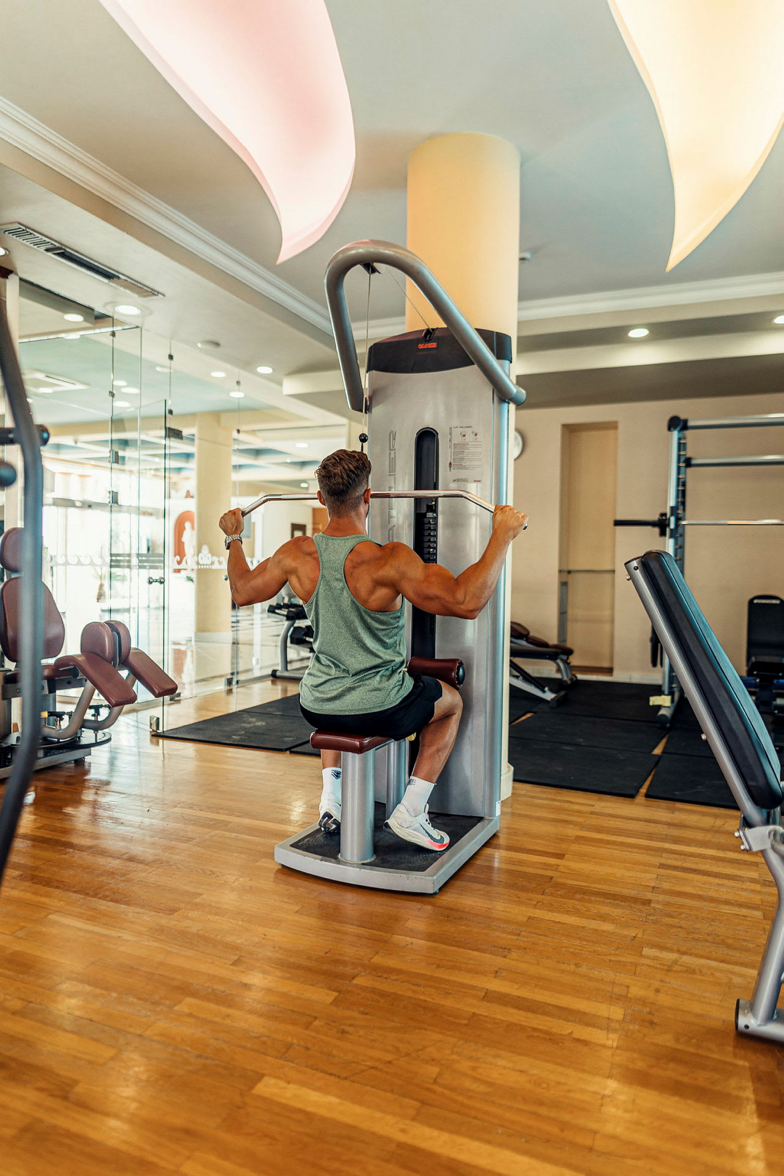 Person tränar på en gymmaskin i ett ljust gym. (AI-genererad text)