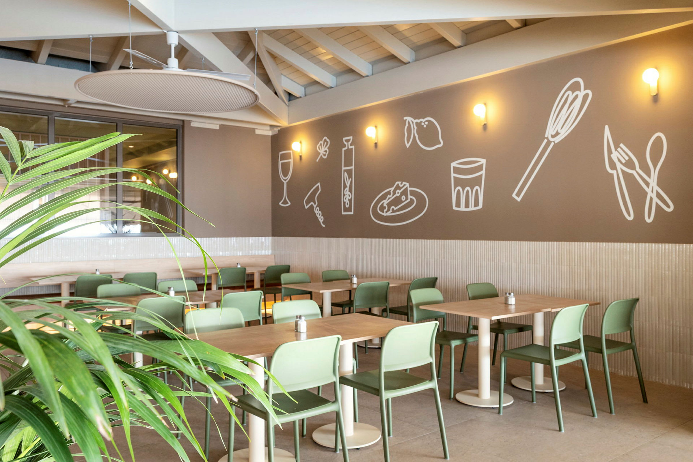 Restaurang med moderna gröna stolar och dekorerad vägg. (AI-genererad text)