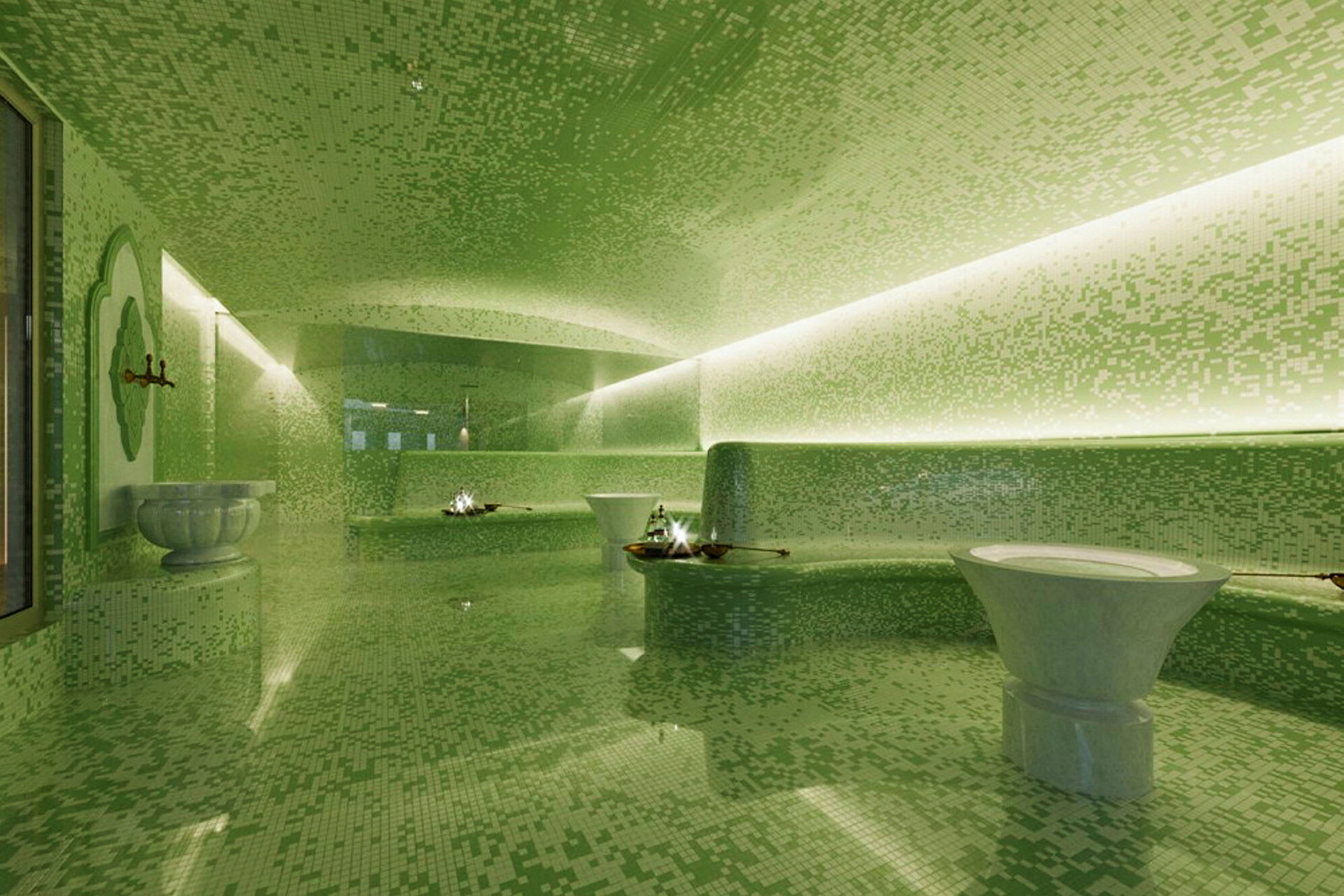 Ett modernt inrett spa med gröna mosaikväggar och fontäner. (AI-genererad text)