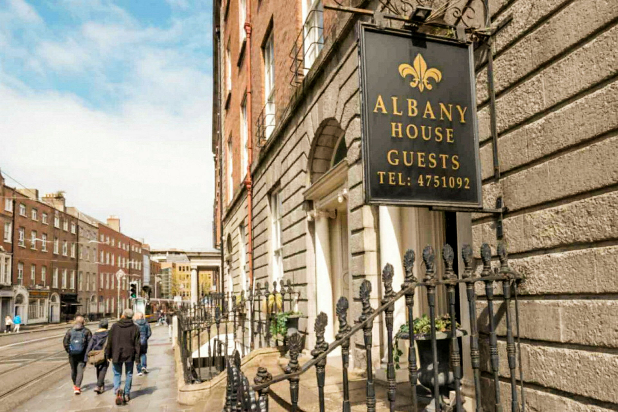 Skylt med texten Albany House Guests vid en husfasad. (AI-genererad text)