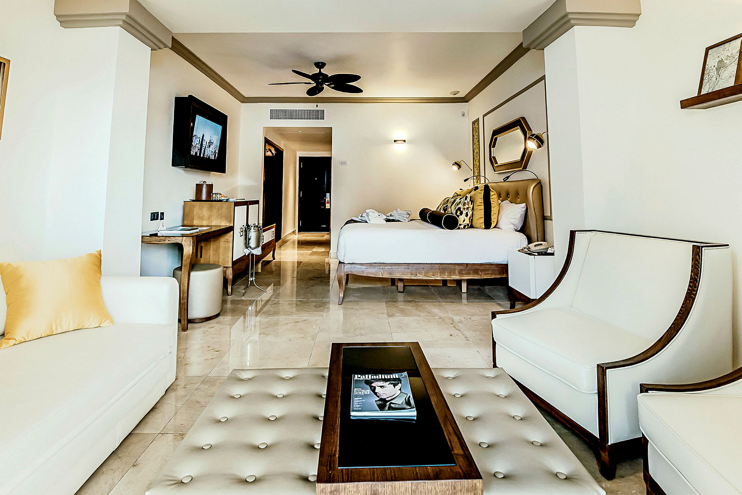 Ett elegant hotellrum med modern inredning, sittgrupp, sovplats och TV. (AI-genererad text)
