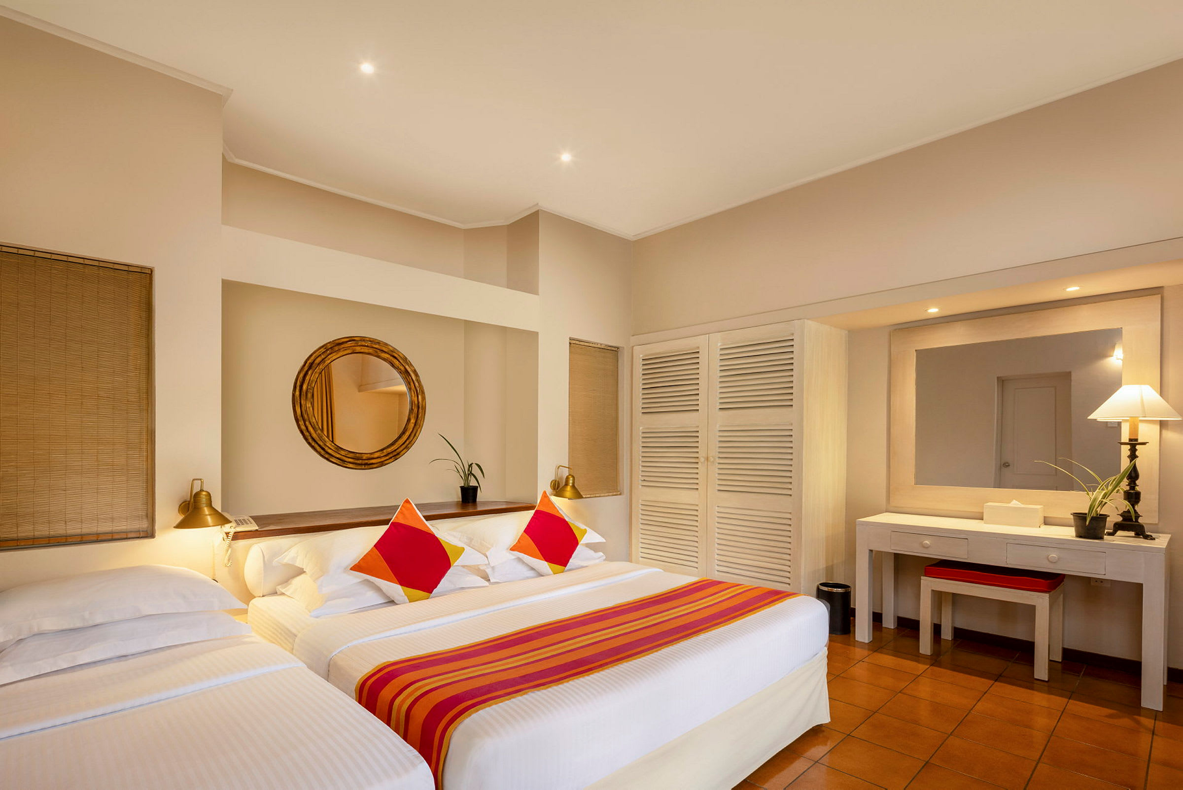 Hotellrum med två bäddar, spegel, garderob och skrivbord. (AI-genererad text)