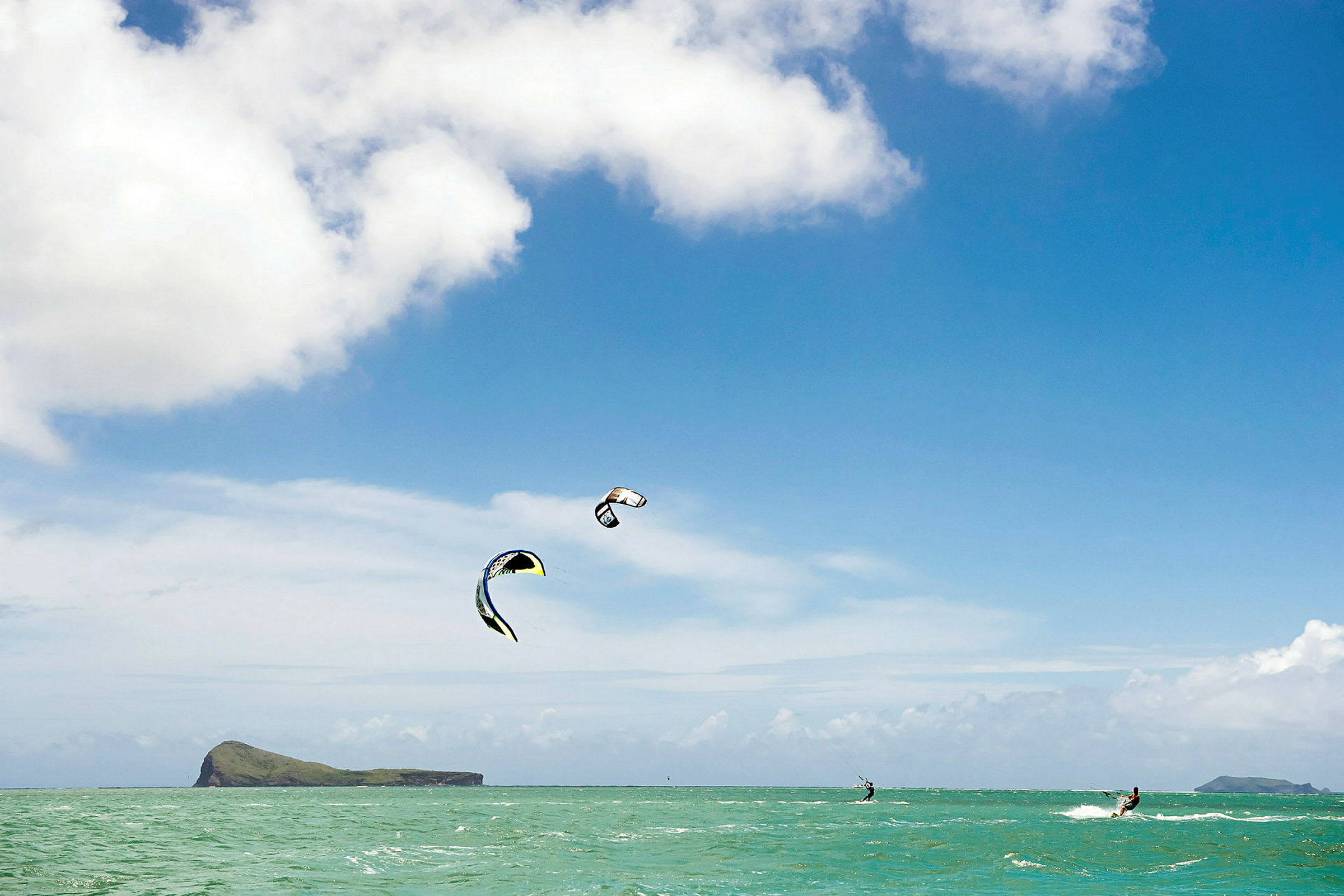 Kitesurfare på havet under klar himmel. (AI-genererad text)