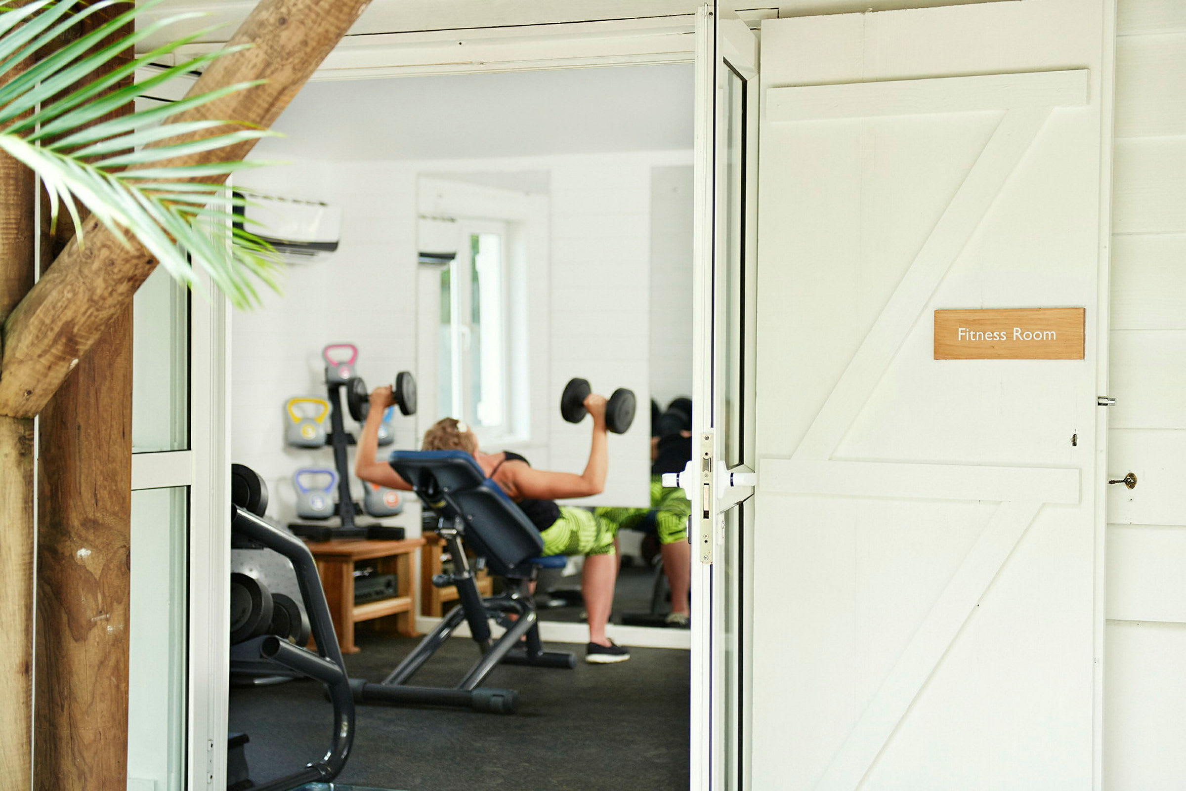 Gym med person som tränar med hantlar. (AI-genererad text)