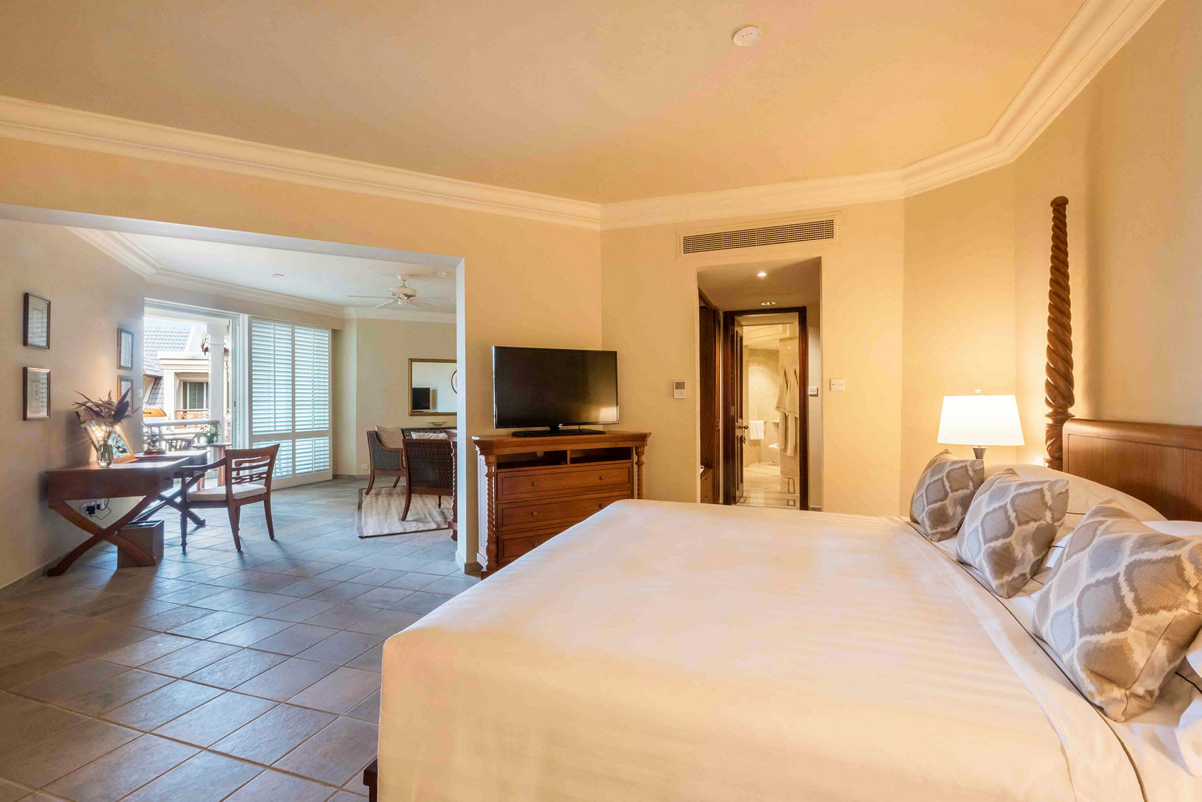 Hotellrum med säng, tv och sittgrupp. (AI-genererad text)