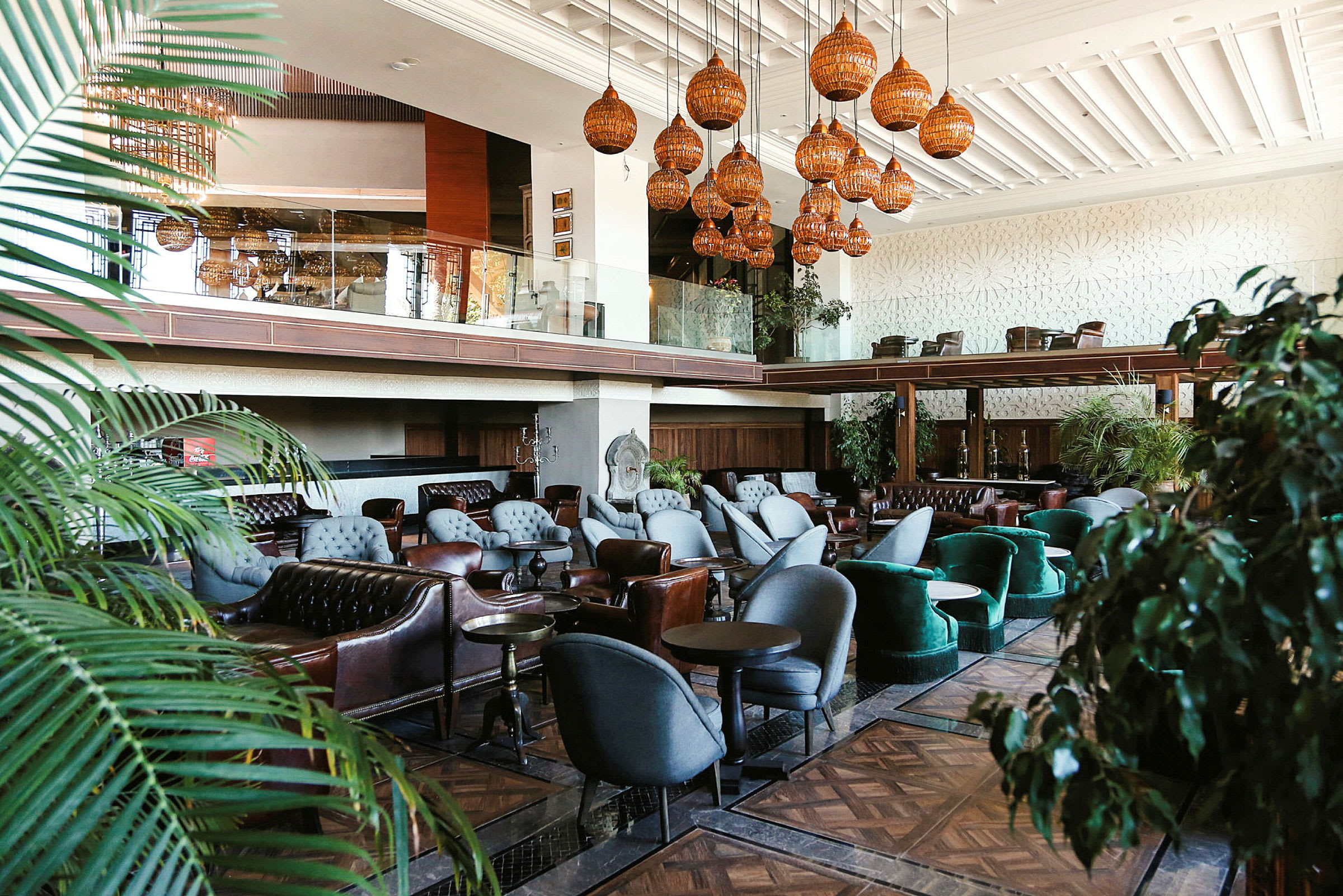 Inredning av ett hotellobbyområde med sittplatser och dekorativa lampor. (AI-genererad text)