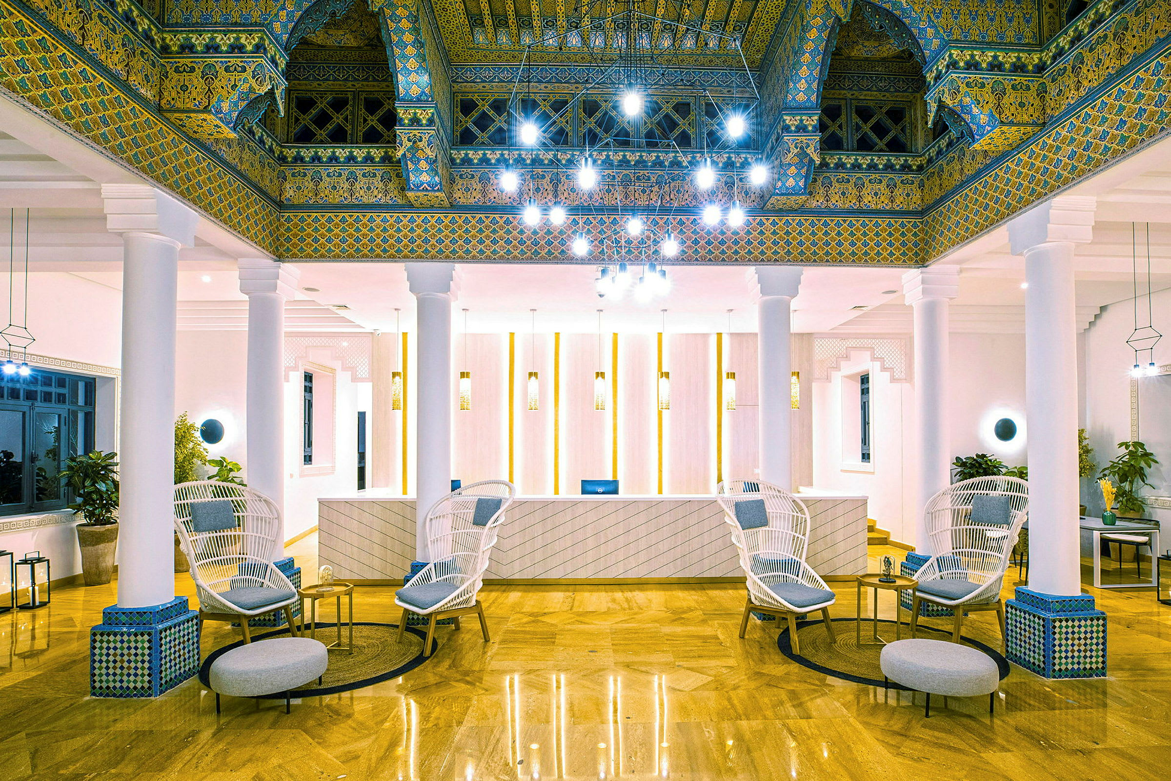 Lobbyn på ett hotell med elegant inredning, inklusive stolar, bord och dekorativa takdetaljer. (AI-genererad text)