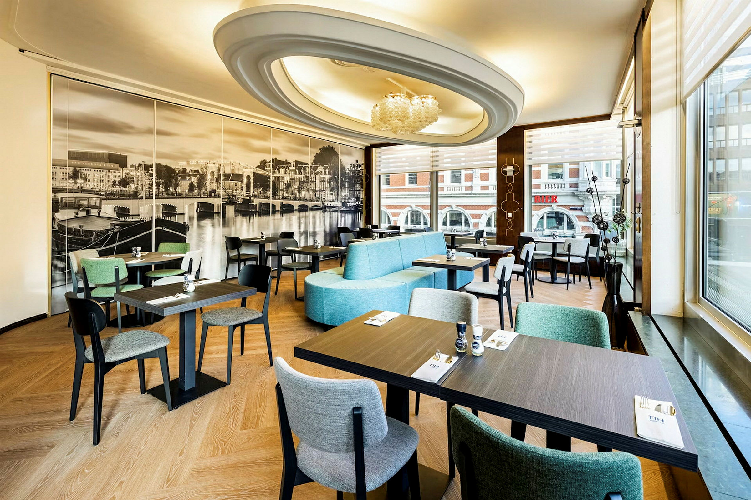 En restaurang interiör med moderna möbler och stort fototapet av en stadsutsikt på väggen. (AI-genererad text)