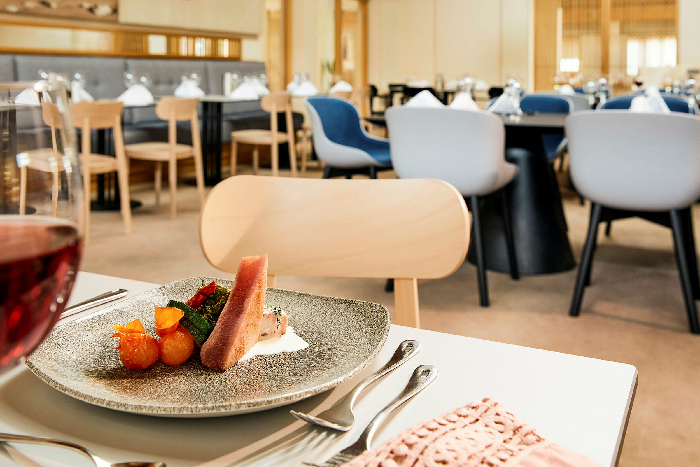 En tallrik med mat står på ett dukat bord i en restaurang. (AI-genererad text)