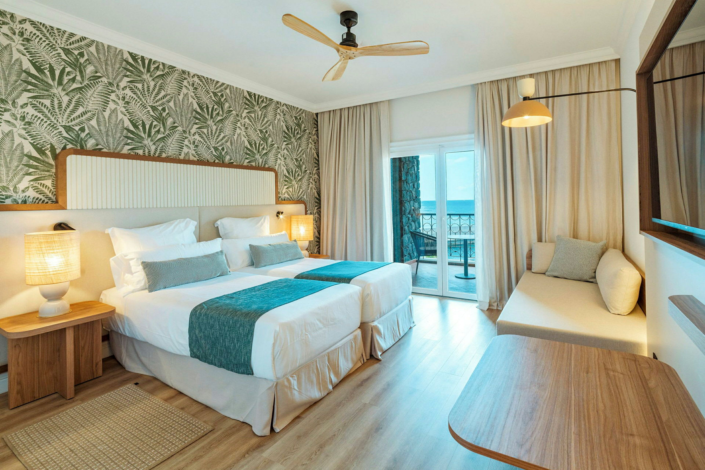 Hotellrum med två enkelsängar och en balkong med havsutsikt. (AI-genererad text)