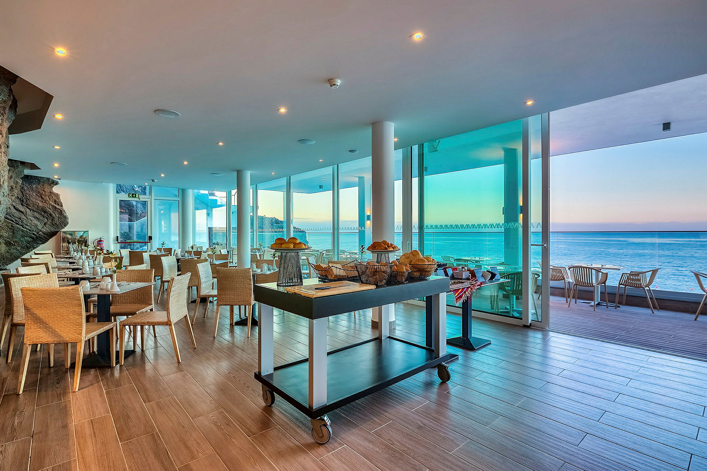 Restaurang med utsikt över havet och dukade bord. (AI-genererad text)
