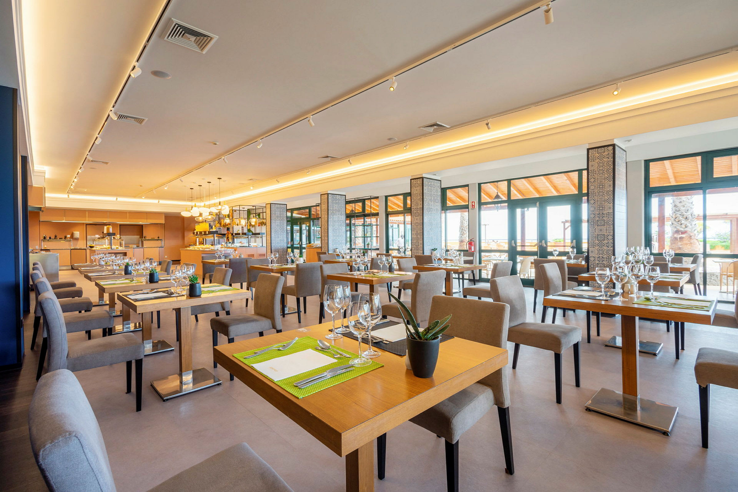 Bild av en ljus och modern restaurang med bord och stolar. (AI-genererad text)
