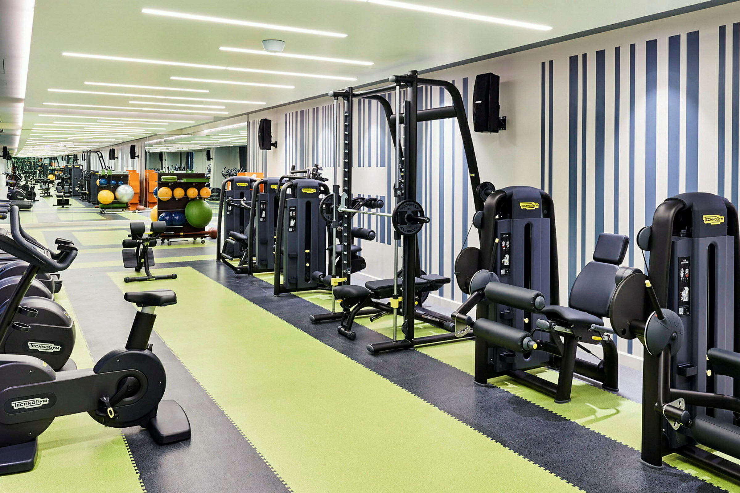 Ett modernt gym med olika träningsmaskiner och fria vikter. (AI-genererad text)