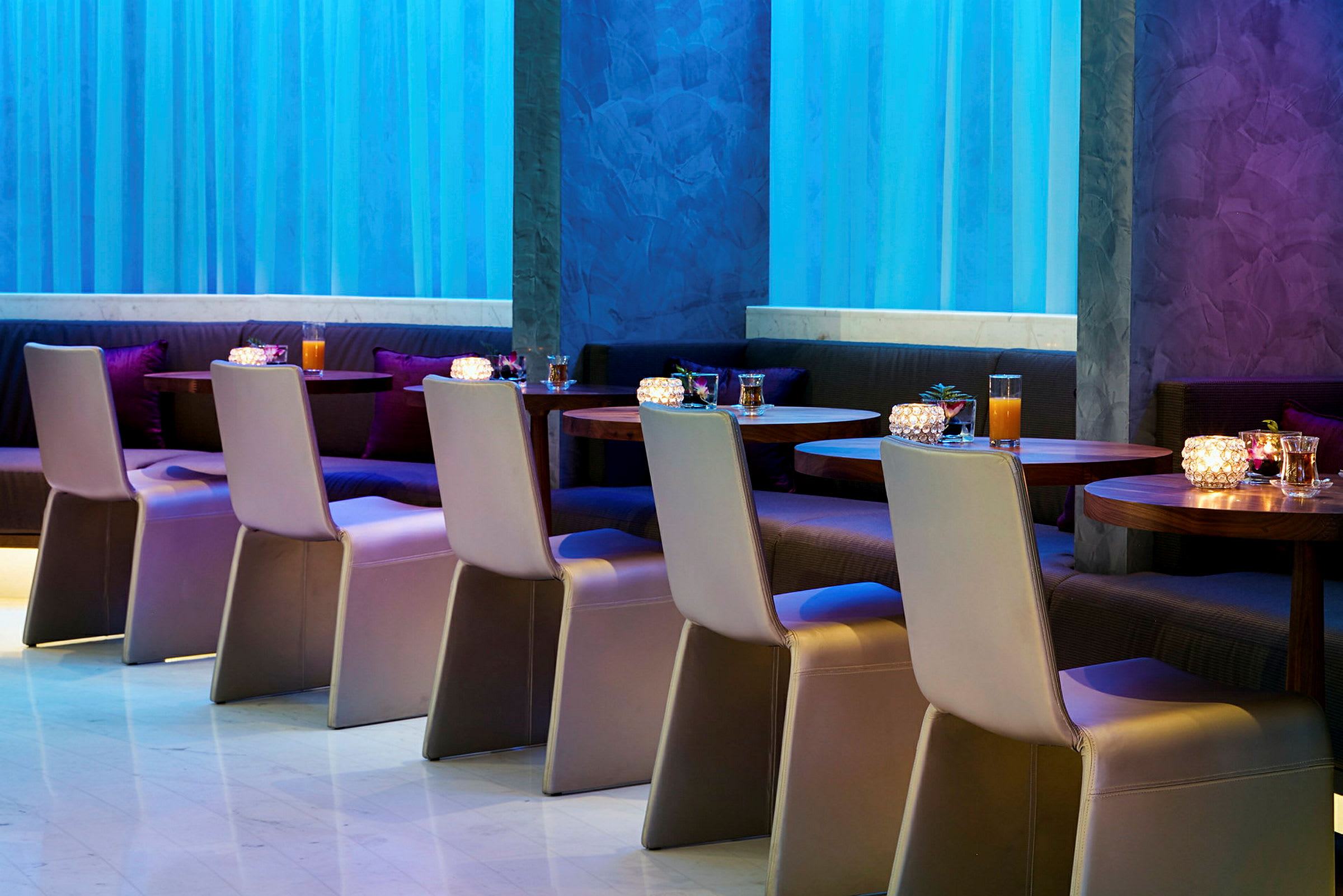 Restaurang med bord och stolar uppställda i en modern inomhusmiljö. (AI-genererad text)