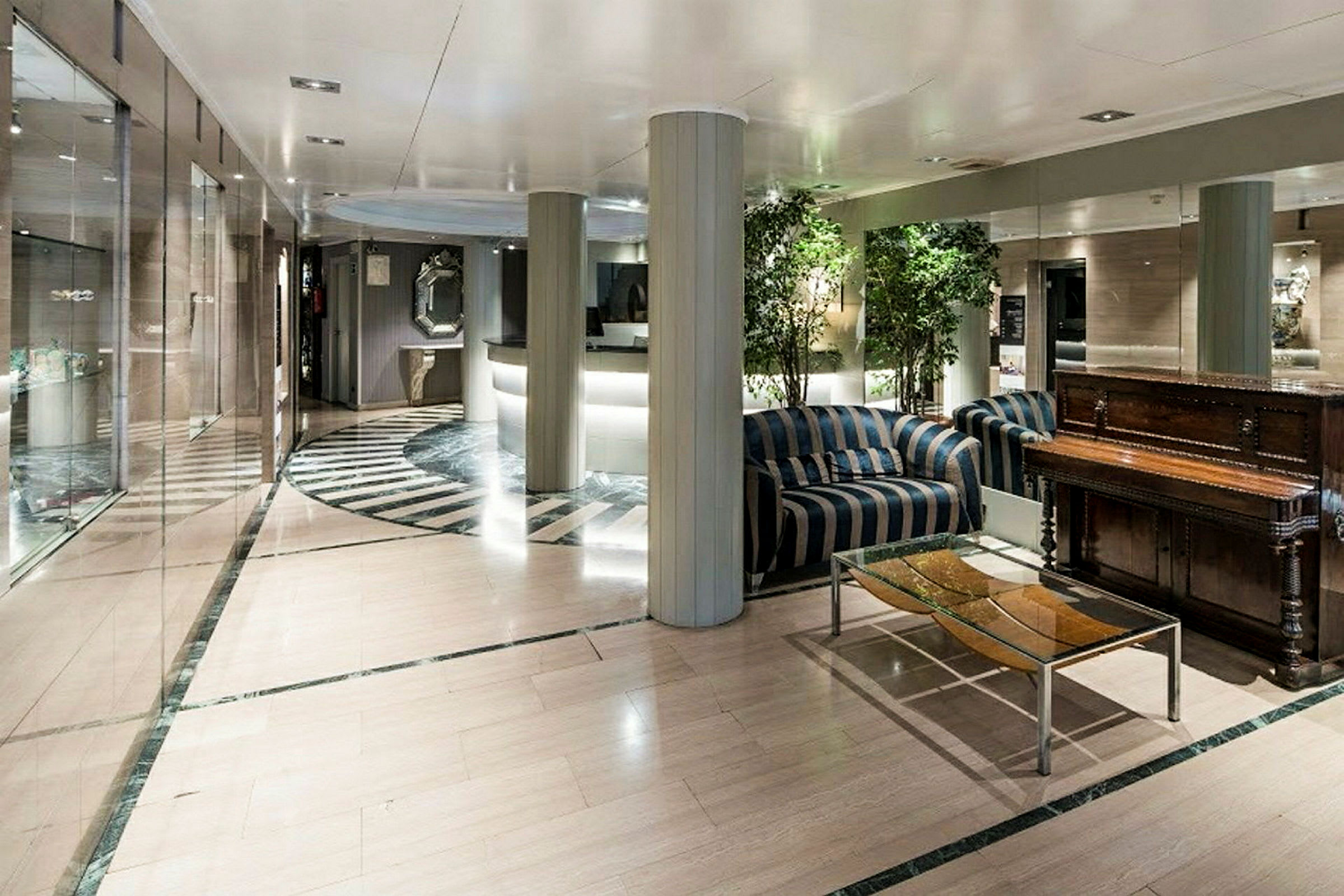 Interiör av en hotellobby med soffor, ett bord och en receptionsdisk. (AI-genererad text)