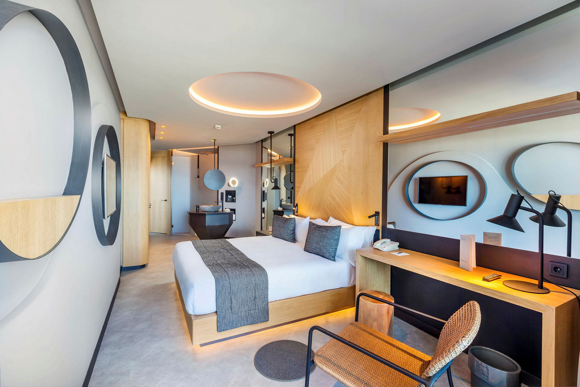 Moderna hotellrum med stor dubbelsäng, skrivbord och TV. (AI-genererad text)