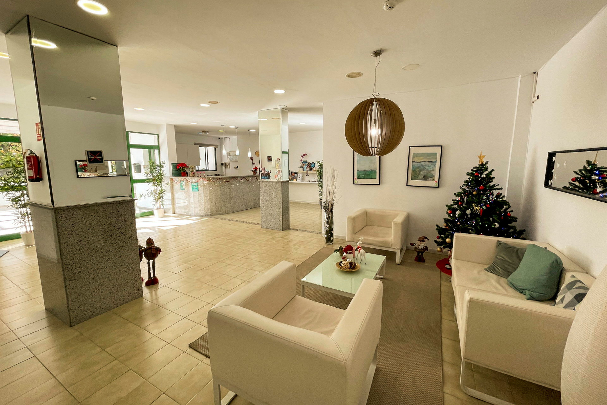 Ett hotellobbyn med juldekorationer och en julgran. (AI-genererad text)