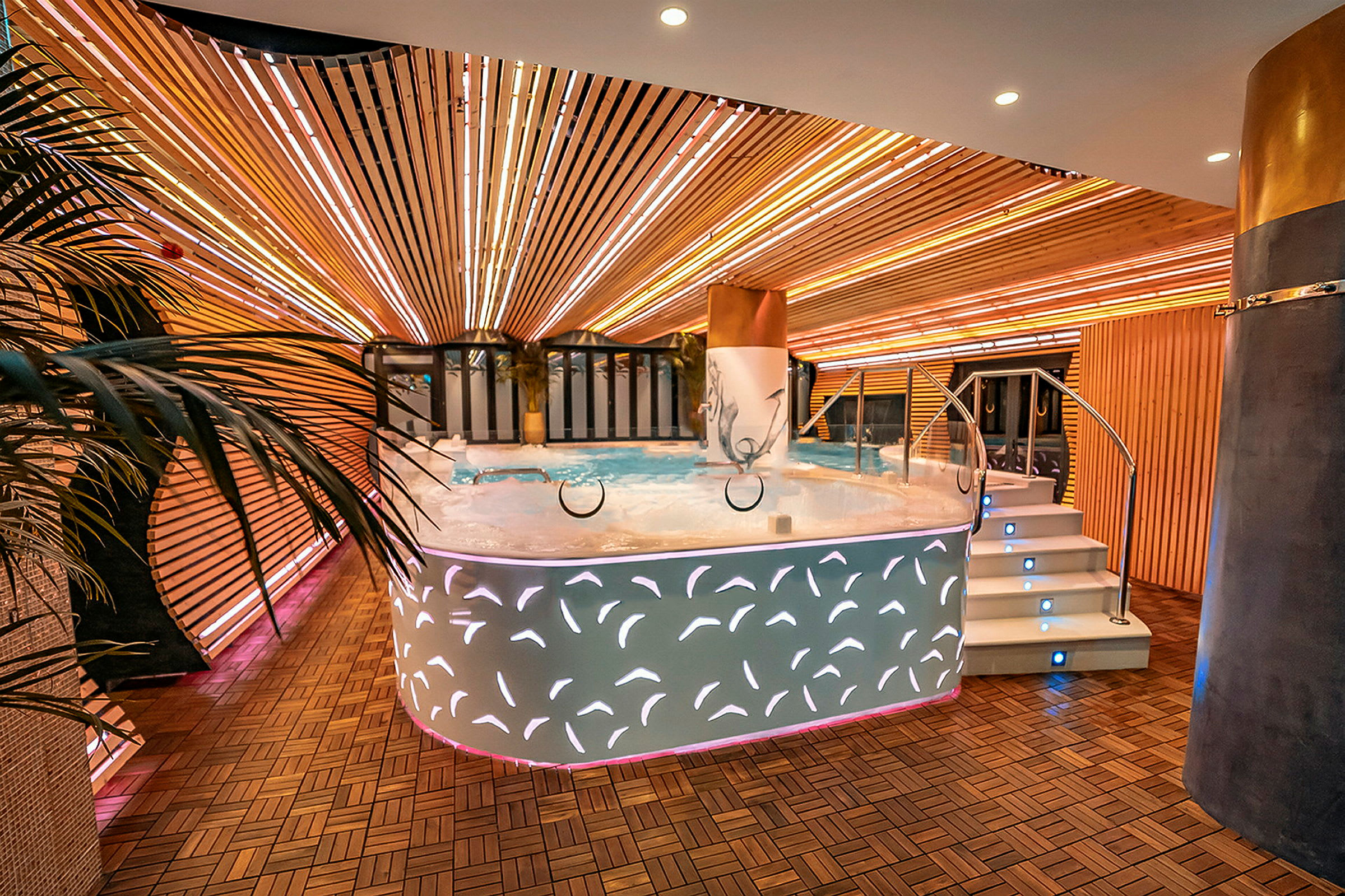 Ett modernt och upplyst spa med ett bubbelbad i mitten. (AI-genererad text)