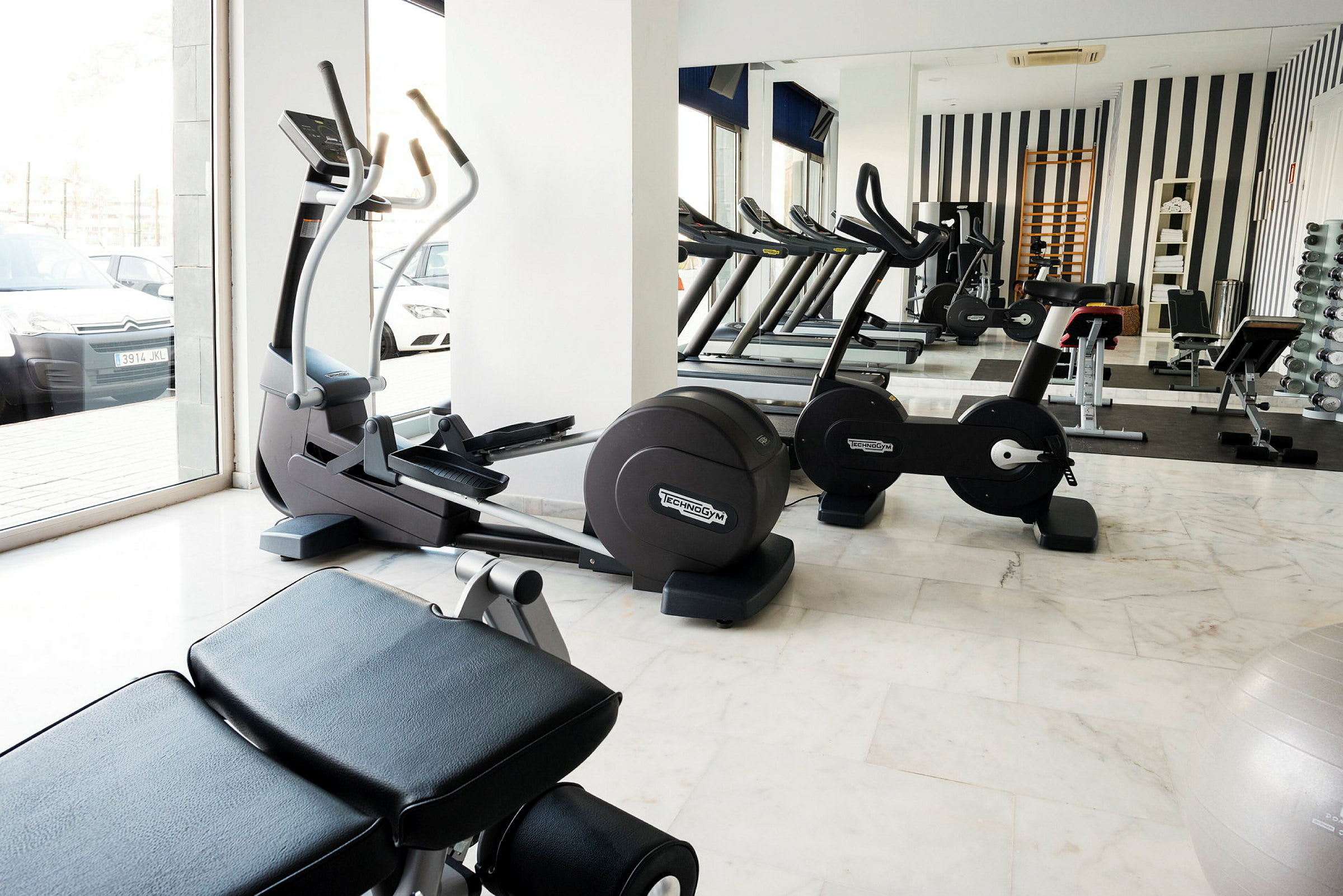 Ett gym med träningsmaskiner och fria vikter. (AI-genererad text)