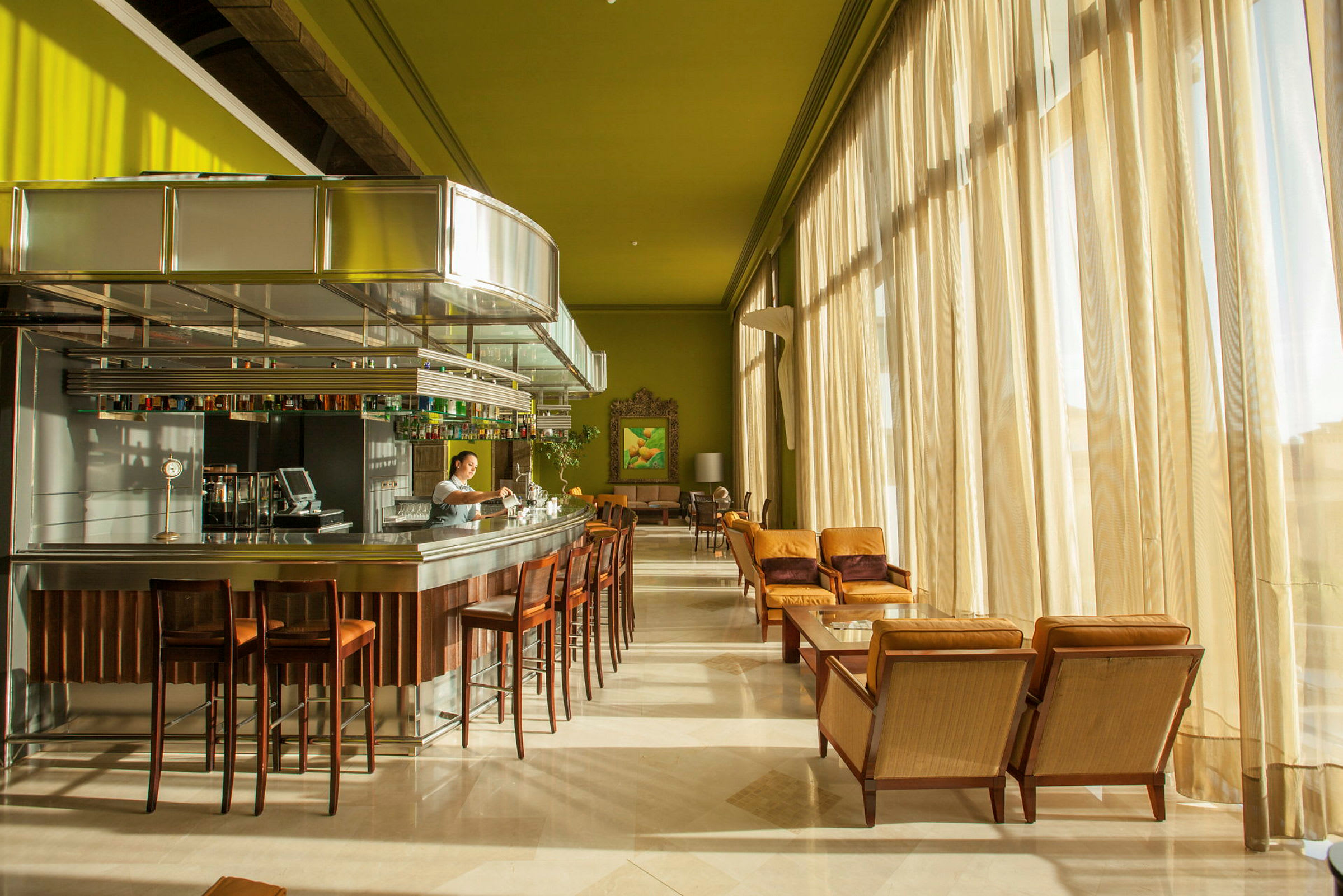 Elegant bar med moderna stolar och bord vid stora fönster. (AI-genererad text)