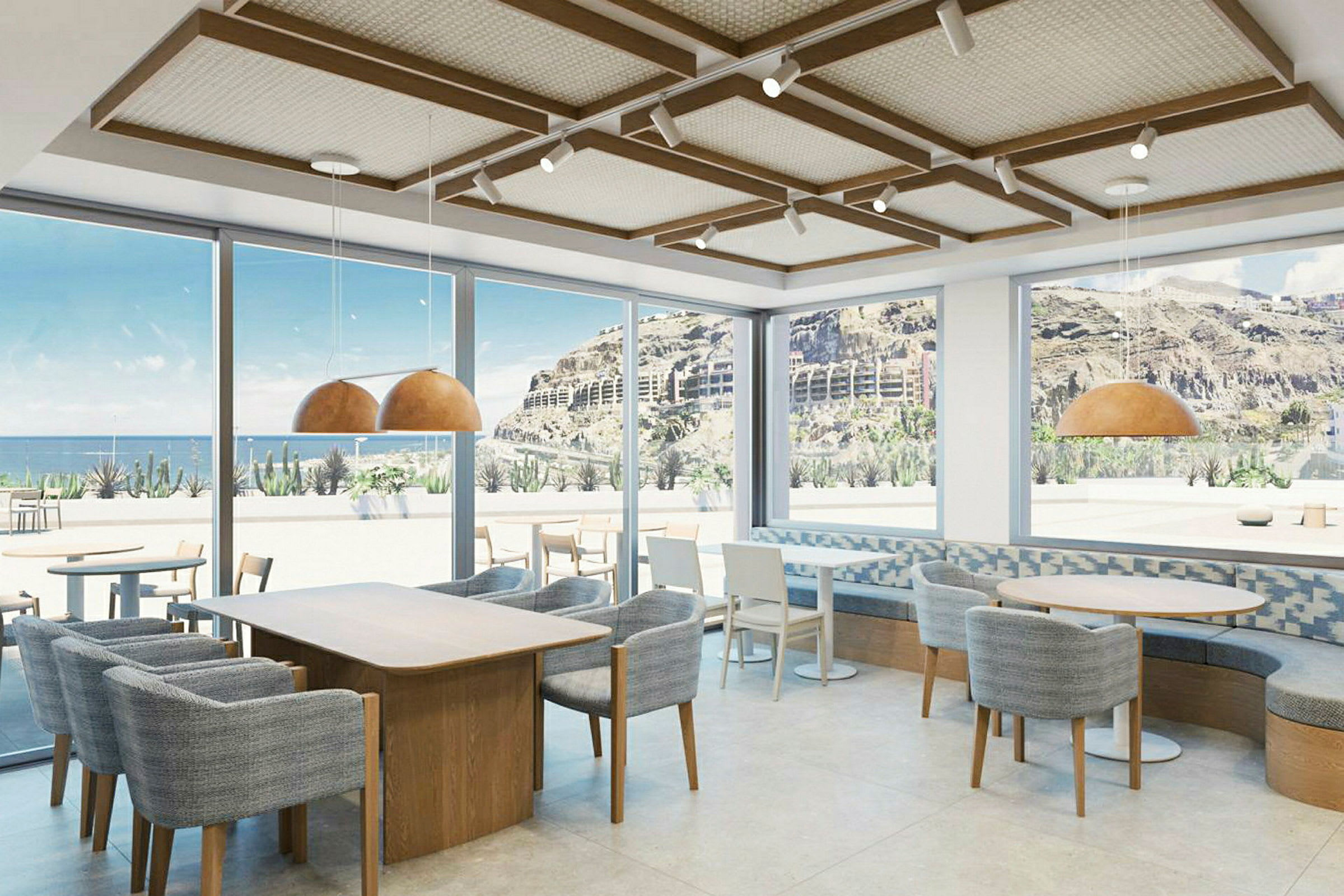 Modernt café med stora fönster och utsikt över berg och hav. (AI-genererad text)
