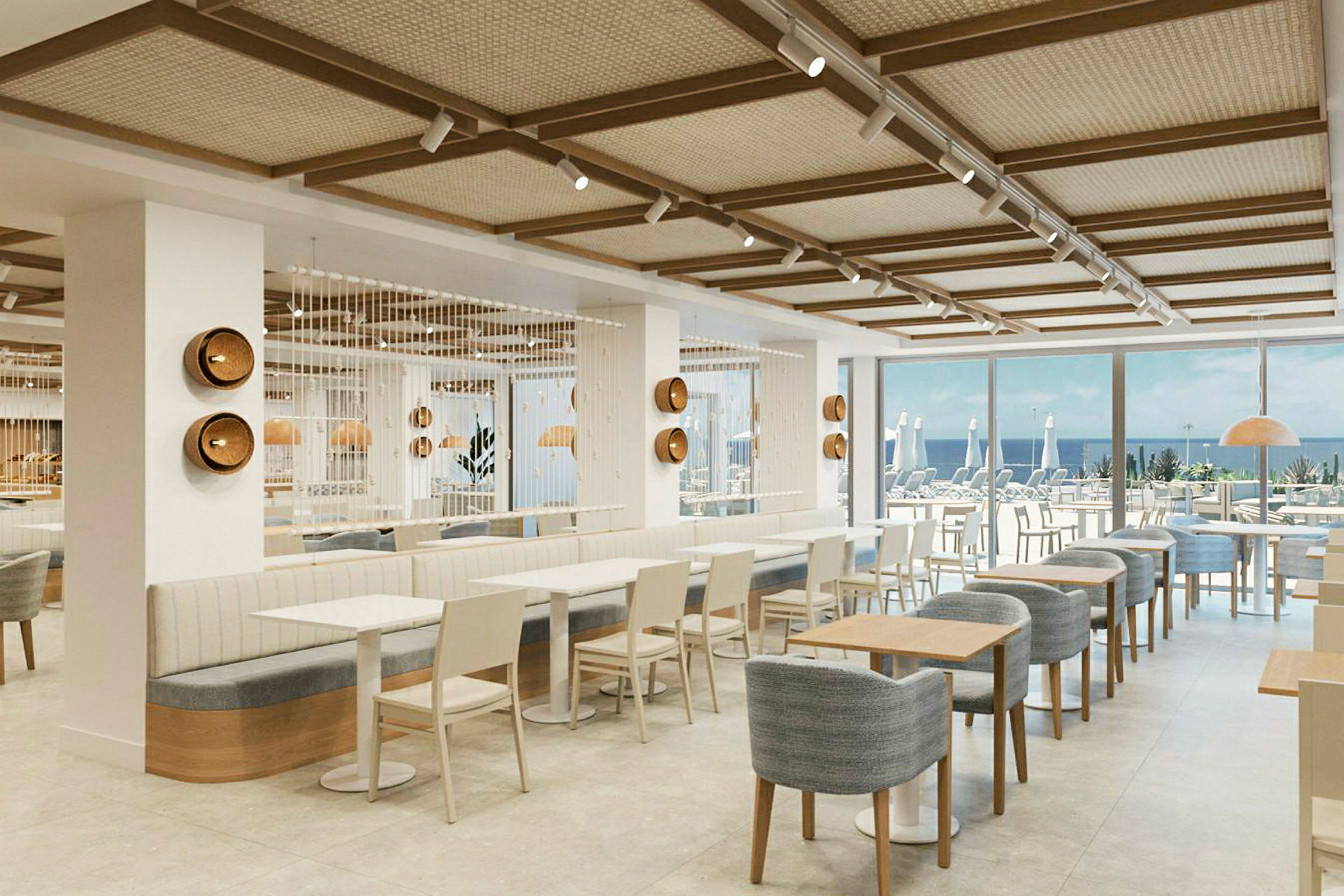 Interiör av en modern restaurang med sittplatser och utsikt mot havet. (AI-genererad text)