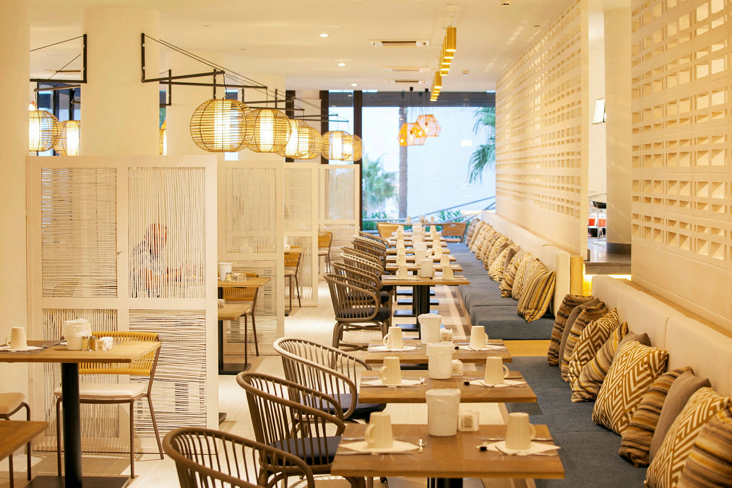 Bild av en modern restaurang med bord, stolar och lampor. (AI-genererad text)