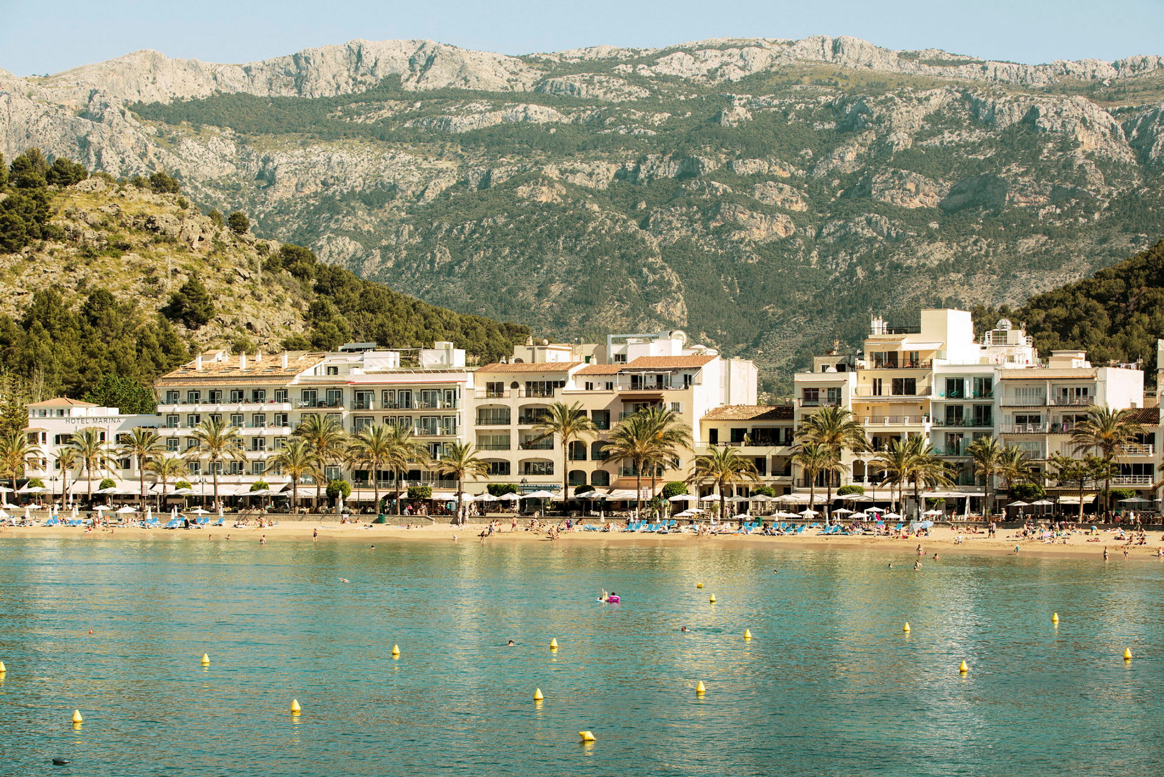 Strand med hotell och berg i bakgrunden. (AI-genererad text)