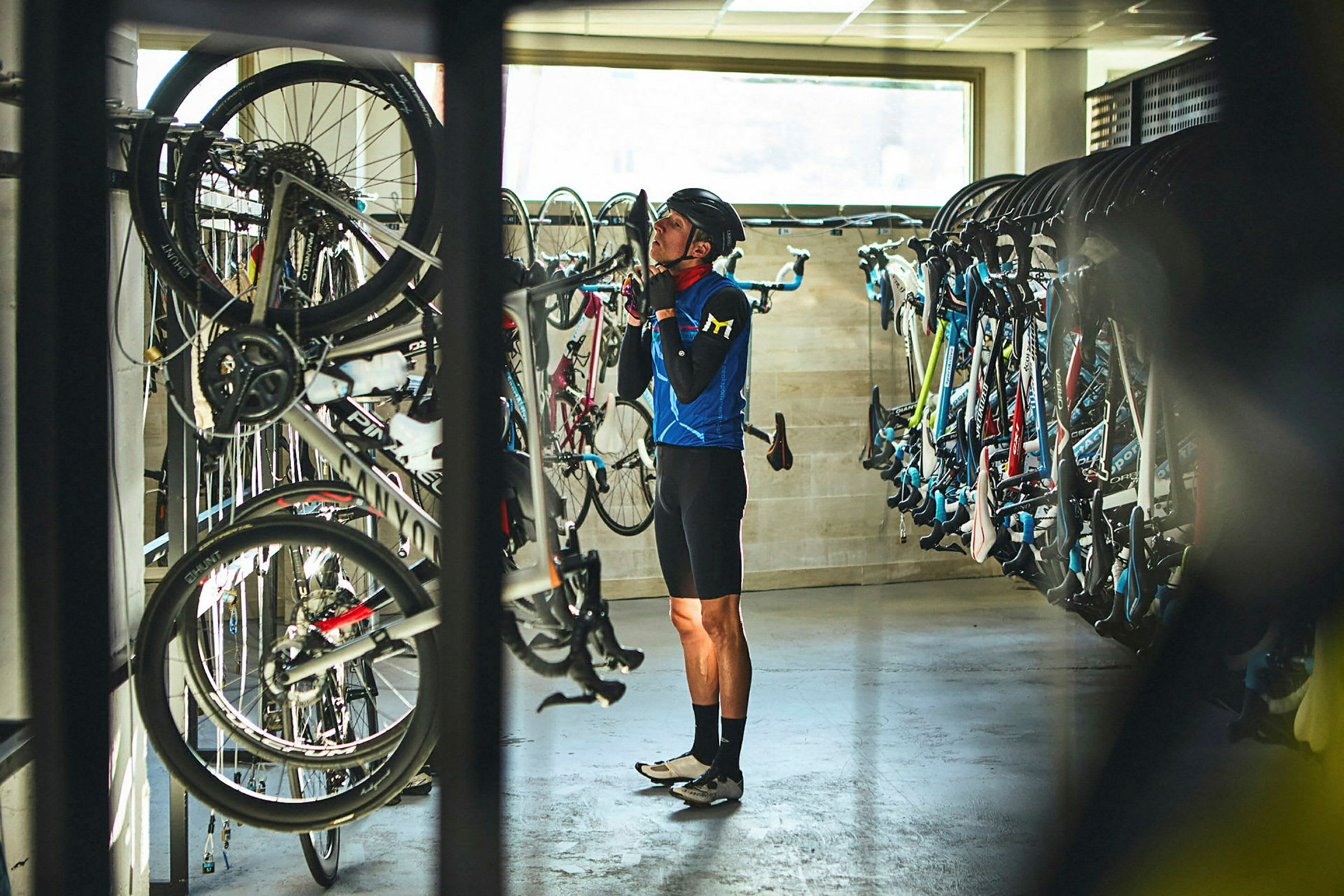 Cyklar är parkerade på ställ i ett rum. (AI-genererad text)