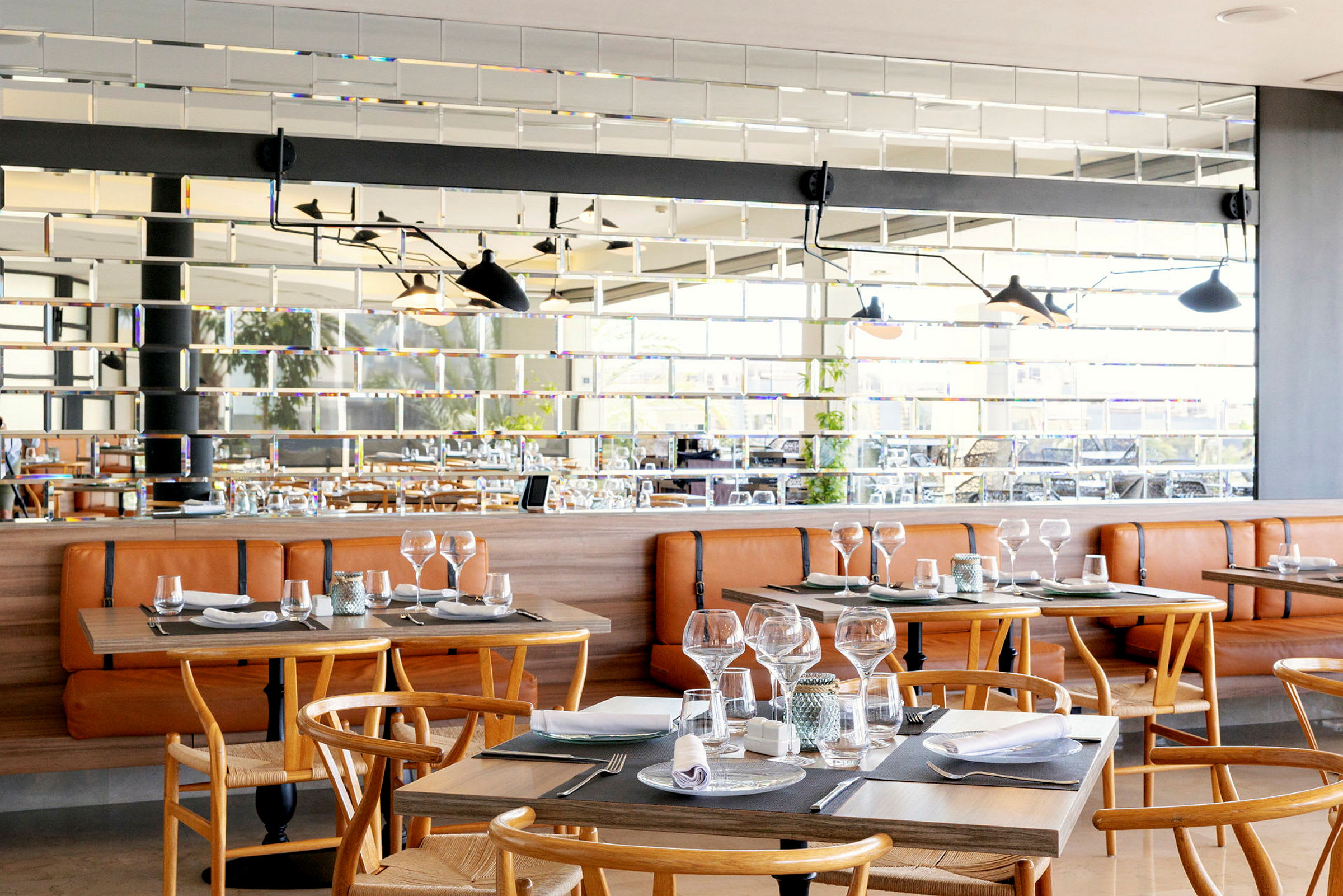 Interiör av en restaurang med trästolar och dukade bord. (AI-genererad text)